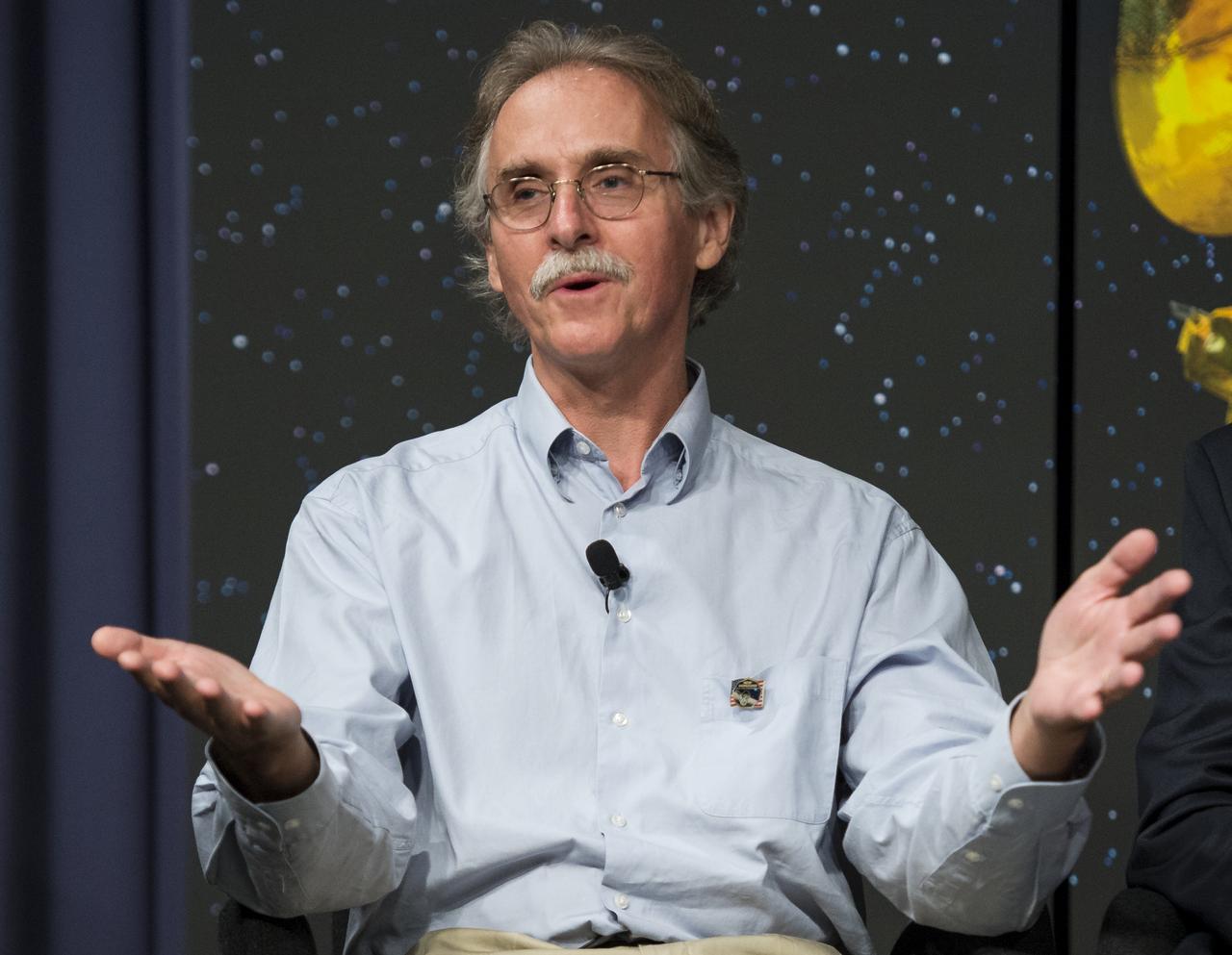 Dr. John Spencer, senior scientist at the Southwest Research Institute in Boulder, Colorado, speaks during a panel discussion at the "NASA's New Horizons Pluto Mission: Continuing Voyager's Legacy of Exploration" event on Monday, August, 25, 2014, in the James E. Webb Auditorium at NASA Headquarters in Washington, DC.  The panelists gave their accounts of Voyager's encounter with Neptune and discussed their current assignments on NASA's New Horizons mission to Pluto.  Photo Credit: (NASA/Joel Kowsky)