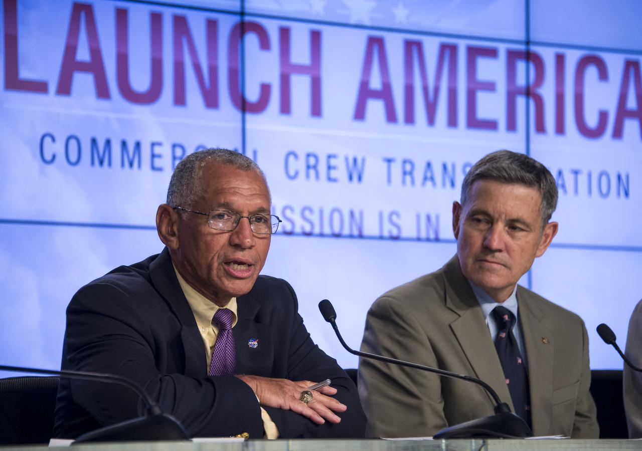 NASA Administrator Charles Bolden, left, announces the agency’s selection of Boeing and SpaceX to transport U.S. crews to and from the International Space Station using the Boeing CST-100 and the SpaceX Crew Dragon spacecraft as Former astronaut Bob Cabana, director of NASA's Kennedy Space Center in Florida looks on at NASA’s Kennedy Space Center in Cape Canaveral, Fla. on Tuesday, Sept. 16, 2014. These Commercial Crew Transportation Capability (CCtCap) contracts are designed to complete the NASA certification for a human space transportation system capable of carrying people into orbit. Once certification is complete, NASA plans to use these systems to transport astronauts to the space station and return them safely to Earth.  Photo Credit: (NASA/Bill Ingalls)