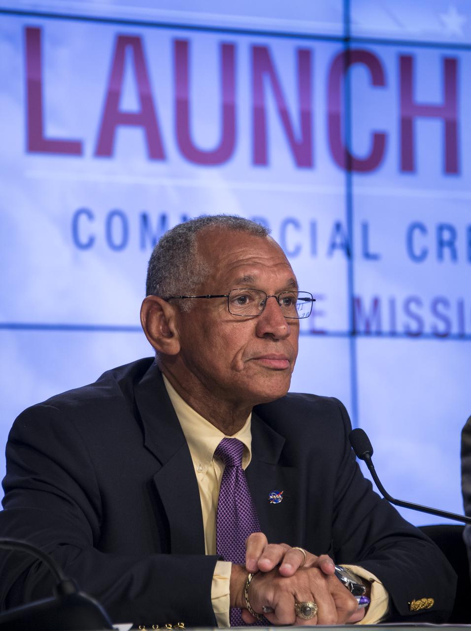 NASA Administrator Charles Bolden listens to a reporter’s question after he announced the agency’s selection of Boeing and SpaceX to transport U.S. crews to and from the International Space Station using the Boeing CST-100 and the SpaceX Crew Dragon spacecraft, at NASA’s Kennedy Space Center in Cape Canaveral, Fla. on Tuesday, Sept. 16, 2014. These Commercial Crew Transportation Capability (CCtCap) contracts are designed to complete the NASA certification for a human space transportation system capable of carrying people into orbit. Once certification is complete, NASA plans to use these systems to transport astronauts to the space station and return them safely to Earth.  Photo Credit: (NASA/Bill Ingalls)