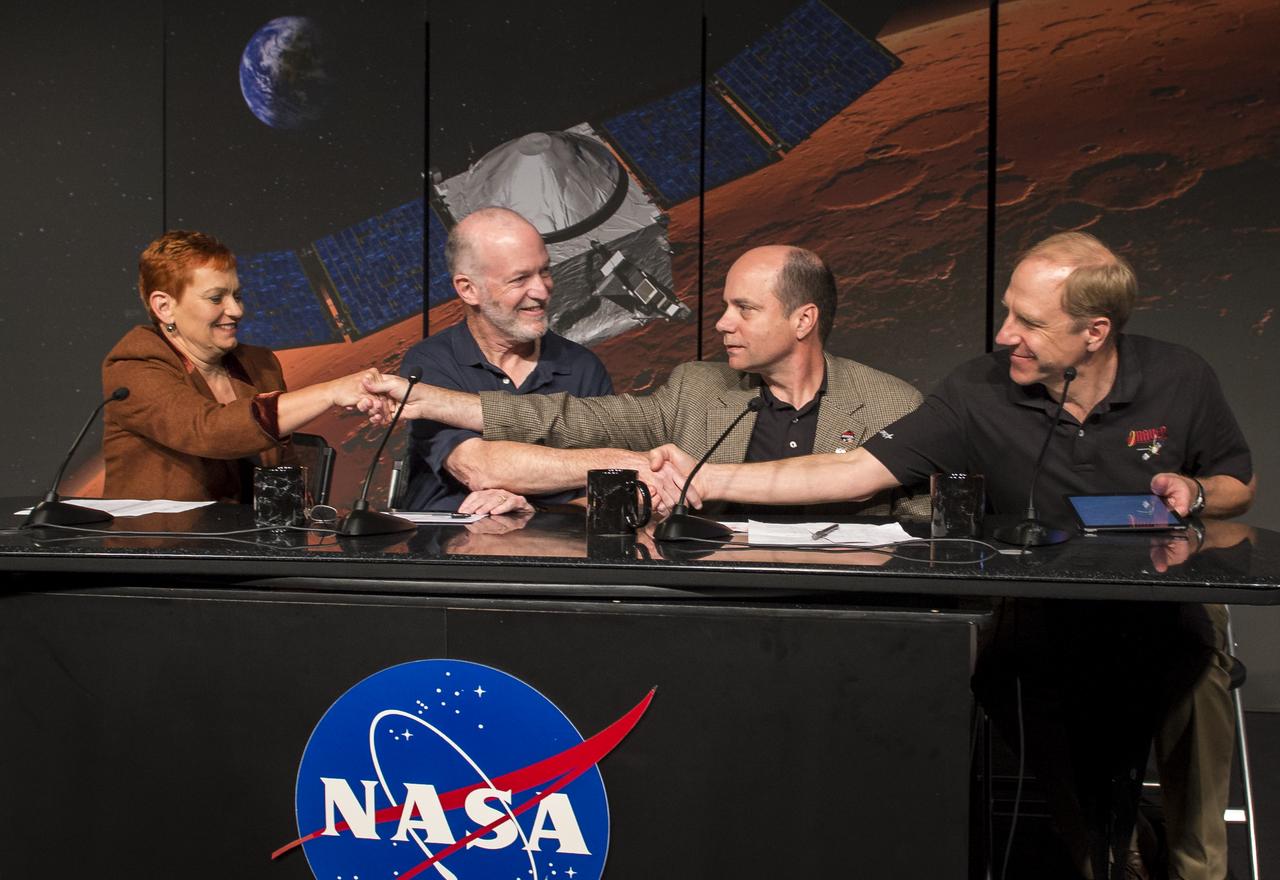 Panelist, from left, Lisa May, lead program executive, Mars Exploration Program, NASA Headquarters, Washington, Bruce Jakosky, MAVEN principal investigator, Laboratory for Atmospheric and Space Physics, University of Colorado, Boulder, David Mitchell, MAVEN project manager, NASA’s Goddard Space Flight Center, Greenbelt, Maryland, and Guy Beutelschies, Lockheed Martin MAVEN program manager, Lockheed Martin Space Systems Company, Littleton, Colorado, all shake hands at the end of a media briefing where they outlined activities around the Sunday, Sept. 21 orbital insertion at Mars of the agency’s Mars Atmosphere and Volatile EvolutioN (MAVEN) spacecraft, Wednesday, Sept. 17, 2014 at NASA Headquarters in Washington. (Photo credit: NASA/Bill Ingalls)
