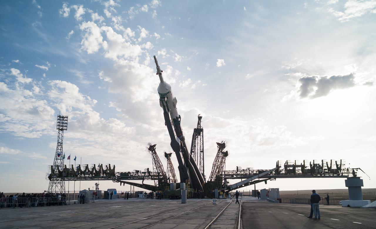 The Soyuz TMA-14M spacecraft is raised into position on the launch pad Sept. 23, 2014 at the Baikonur Cosmodrome in Kazakhstan. Launch of the Soyuz rocket is scheduled for Sept. 26 and will carry Expedition 41 Soyuz Commander Alexander Samokutyaev of the Russian Federal Space Agency (Roscosmos), Flight Engineer Barry Wilmore of NASA, and Flight Engineer Elena Serova of Roscosmos into orbit to begin their five and a half month mission on the International Space Station. Photo Credit: (NASA/Joel Kowsky)