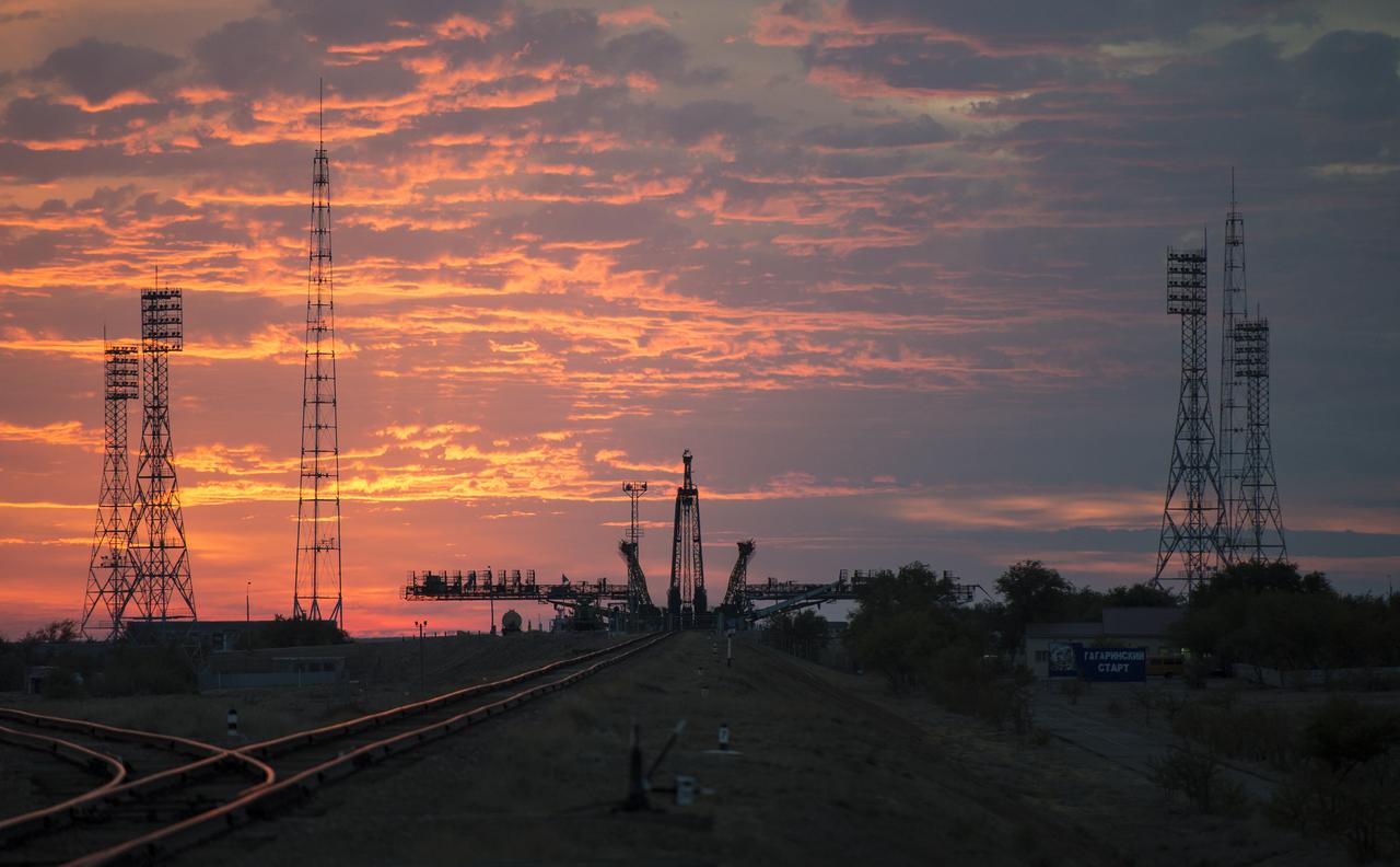 The sun rises behind the Soyuz launch pad as the Soyuz TMA-14M spacecraft is rolled out by train to the launch pad at the Baikonur Cosmodrome, Kazakhstan, Sept. 23, 2014. Launch of the Soyuz rocket is scheduled for Sept. 26 and will carry Expedition 41 Soyuz Commander Alexander Samokutyaev of the Russian Federal Space Agency (Roscosmos), Flight Engineer Barry Wilmore of NASA, and Flight Engineer Elena Serova of Roscosmos into orbit to begin their five and a half month mission on the International Space Station. Photo Credit: (NASA/Joel Kowsky)