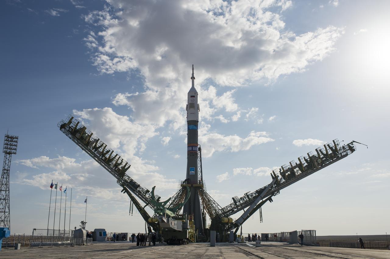 The gantry arms begin to close around the Soyuz TMA-14M spacecraft to secure the rocket at the launch pad Sept. 23, 2014 at the Baikonur Cosmodrome in Kazakhstan. Launch of the Soyuz rocket is scheduled for Sept. 26 and will carry Expedition 41 Soyuz Commander Alexander Samokutyaev of the Russian Federal Space Agency (Roscosmos), Flight Engineer Barry Wilmore of NASA, and Flight Engineer Elena Serova of Roscosmos into orbit to begin their five and a half month mission on the International Space Station. Photo Credit: (NASA/Joel Kowsky)