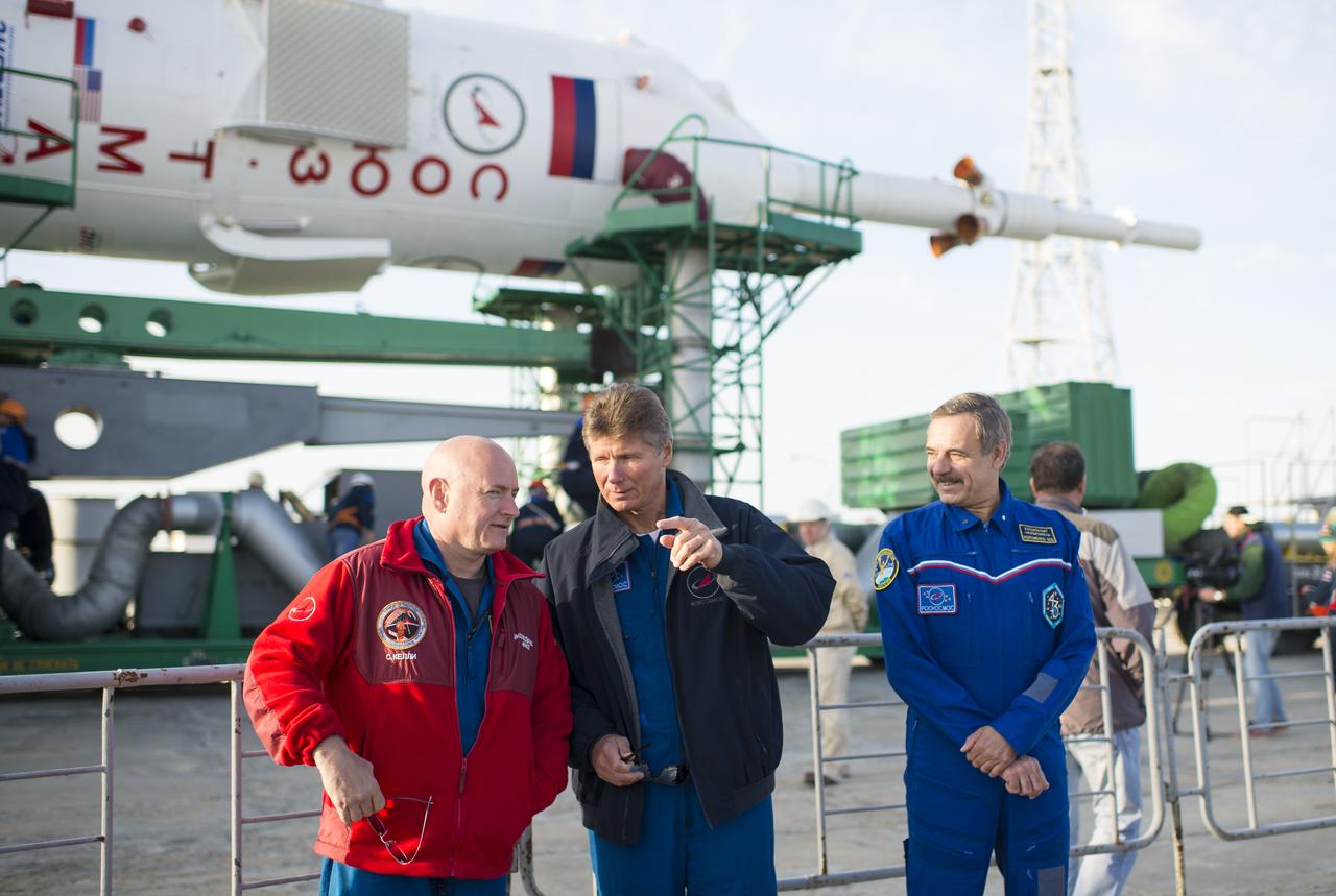 The Expedition 41 backup crew, from left to right, Flight Engineer Scott Kelly of NASA, Soyuz Commander Gennady Padalka of the Russian Federal Space Agency (Roscosmos), and Flight Engineer Mikhail Kornienko of Roscosmos, are photographed in front of the Soyuz TMA-14M spacecraft as it arrives at the launch pad by train on Sept. 23, 2014 at the Baikonur Cosmodrome in Kazakhstan.  Launch of the Soyuz rocket is scheduled for Sept. 26 and will send Expedition 41 Soyuz Commander Alexander Samokutyaev of the Russian Federal Space Agency (Roscosmos), Flight Engineer Barry Wilmore of NASA, and Flight Engineer Elena Serova of Roscosmos on a five and a half month mission aboard the International Space Station.  Kelly and Kornienko will launch from Baikonur in March 2015 to spend a full year on the International Space Station. Photo Credit: (NASA/Joel Kowsky)