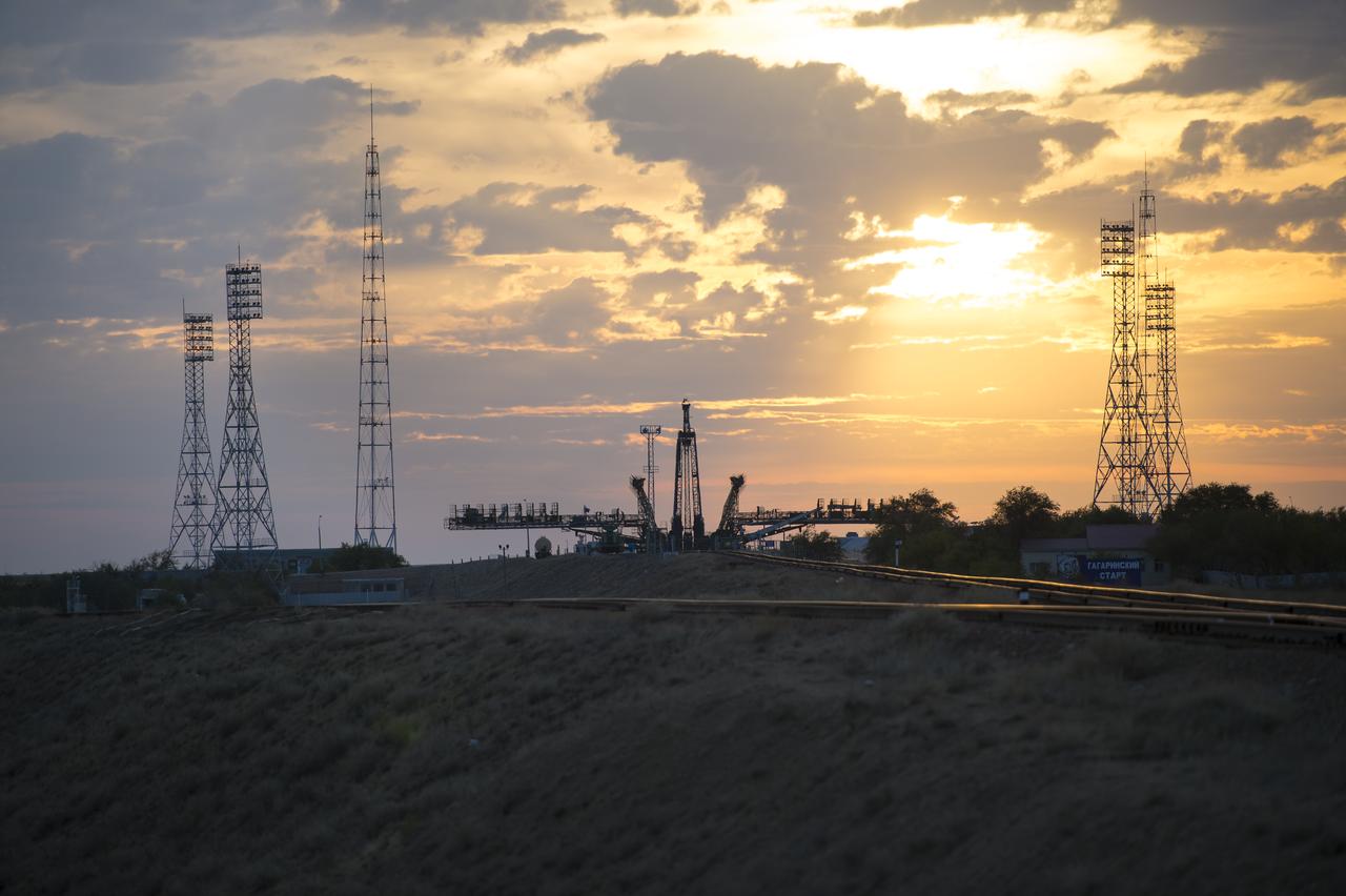 The sun rises behind the Soyuz launch pad as the Soyuz TMA-14M spacecraft is rolled out by train to the launch pad at the Baikonur Cosmodrome, Kazakhstan, Sept. 23, 2014. Launch of the Soyuz rocket is scheduled for Sept. 26 and will carry Expedition 41 Soyuz Commander Alexander Samokutyaev of the Russian Federal Space Agency (Roscosmos), Flight Engineer Barry Wilmore of NASA, and Flight Engineer Elena Serova of Roscosmos into orbit to begin their five and a half month mission on the International Space Station. Photo Credit: (NASA/Aubrey Gemignani)