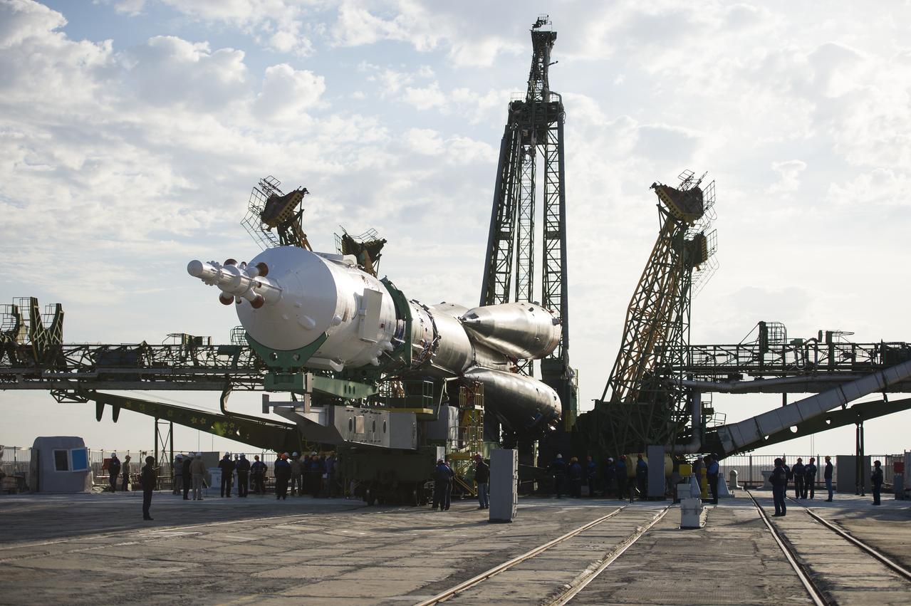 The Soyuz TMA-14M spacecraft is seen shortly after arriving at the launch pad by train on Tuesday, Sept. 23, 2014, at the Baikonur Cosmodrome in Kazakhstan.  Launch of the Soyuz rocket is scheduled for Sept. 26 and will carry Expedition 41 Soyuz Commander Alexander Samokutyaev of the Russian Federal Space Agency (Roscosmos), Flight Engineer Barry Wilmore of NASA, and Flight Engineer Elena Serova of Roscosmos into orbit to begin their five and a half month mission on the International Space Station. Photo Credit: (NASA/Aubrey Gemignani)