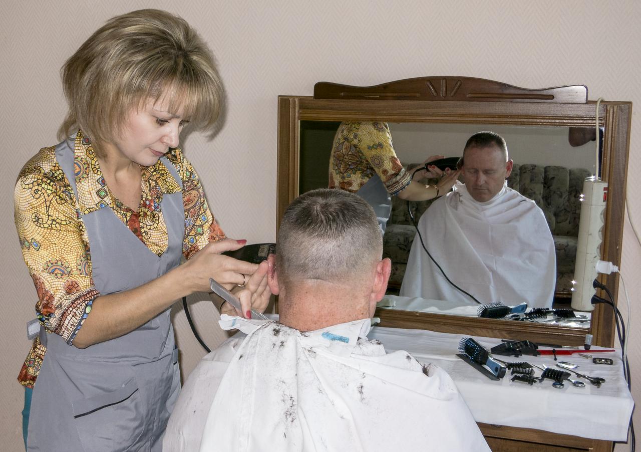 Expedition 41 Flight Engineer Barry Wilmore gets his hair cut at the Cosmonaut Hotel, on Tuesday, Sept. 23, 2014, at the Baikonur Cosmodrome in Kazakhstan. Launch of the Soyuz is scheduled for Sept. 26 and will send Barry Wilmore of NASA, Soyuz Commander Alexander Samokutyaev of the Russian Federal Space Agency (Roscosmos), and Flight Engineer Elena Serova of Roscosmos to the International Space Station for a five and a half month stay.  Photo Credit: (NASA/Dr. Peter Bauer)