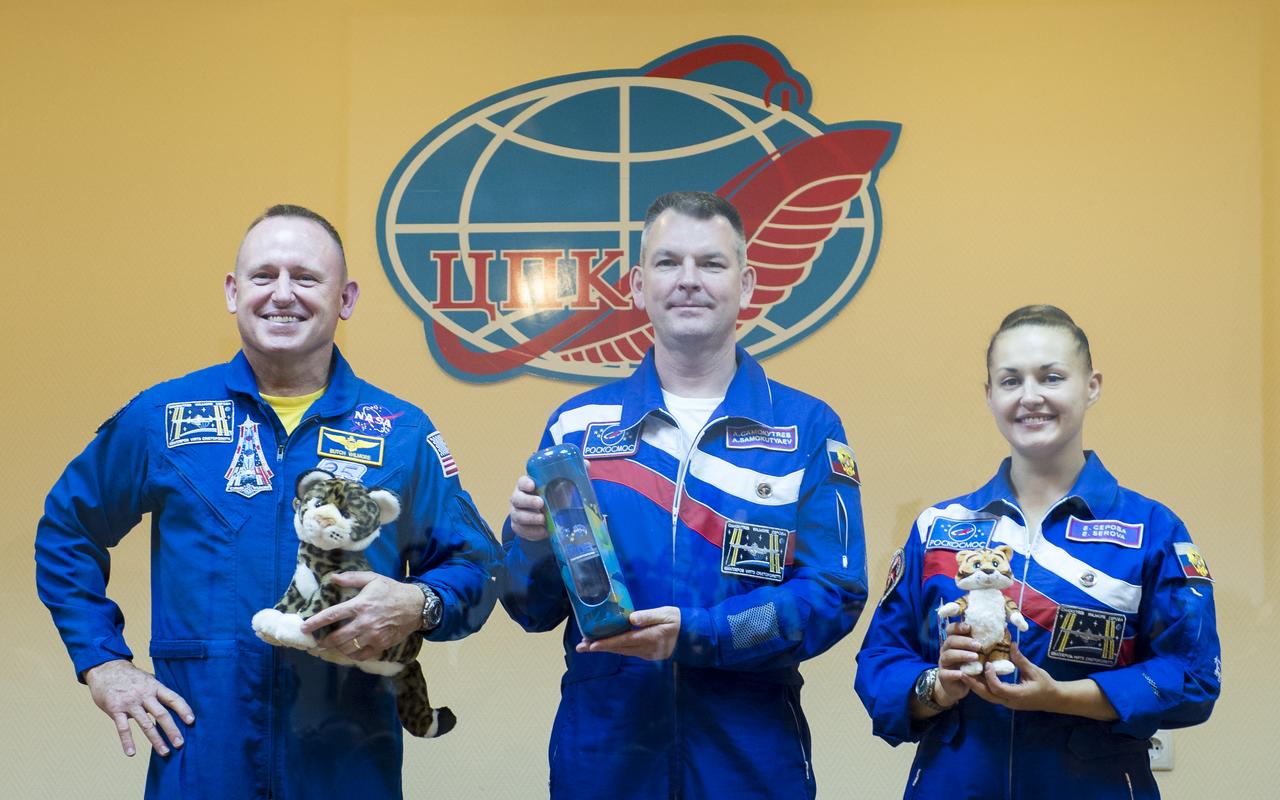 Expedition 41 prime crew members, Flight Engineer Barry Wilmore of NASA, right, Soyuz Commander Alexander Samokutyaev of the Russian Federal Space Agency (Roscosmos), center, and Flight Engineer Elena Serova of Roscosmos, left, pose for a photo with items they will take with them to the International Space Station at the conclusion of the press conference held at the Cosmonaut Hotel in Baikonur, Kazakhstan on Wednesday, Sept. 24, 2014. The mission is set to launch Sept. 26 from the Baikonur Cosmodrome. Photo Credit: (NASA/Aubrey Gemignani)