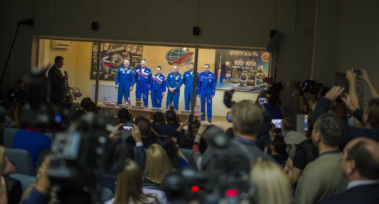 Expedition 41 prime crew members Flight Engineer Barry Wilmore of NASA, far left, Soyuz Commander Alexander Samokutyaev of the Russian Federal Space Agency (Roscosmos), second left, and Flight Engineer Elena Serova, of Roscosmos, center, pose for a picture with Expedition 41 backup crew members Flight Engineer Scott Kelly of NASA, third right, Soyuz Commander Gennady Padalka of Roscosmos, second right, and Flight Engineer Mikhail Kornienko of Roscosmos, far right, at the conclusion of a press conference, Wednesday, September 24, 2014, at the Cosmonaut Hotel in Baikonur, Kazakhstan. Samokutyaev, Serova, and Wilmore will launch about their Soyuz TMA-14M spacecraft in the early hours of September 26.  Serova will become the fourth Russian woman to fly in space and the first Russian woman to live and work on the station. Photo Credit: (NASA/Joel Kowsky)