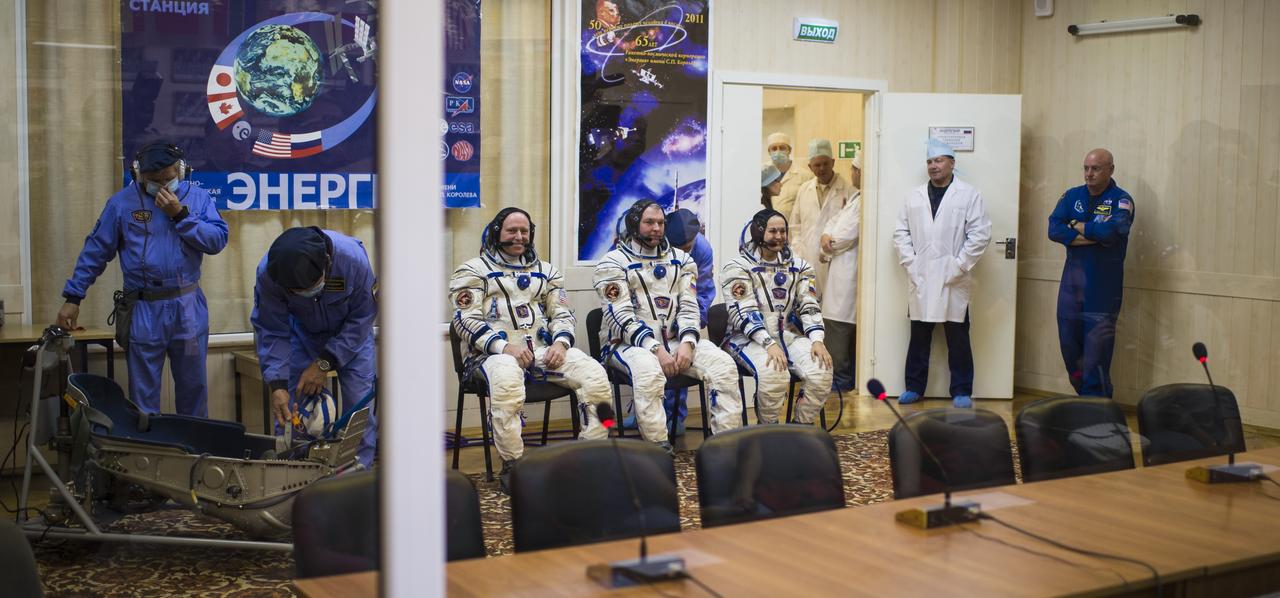 Expedition 41 Flight Engineer Barry Wilmore of NASA, left, Soyuz Commander Alexander Samokutyaev of the Russian Federal Space Agency (Roscosmos), center, and Flight Engineer Elena Serova of Roscosmos, right, are seen prior to having their Russian Sokol suits pressure checked in preparation for their launch onboard the Soyuz TMA-14M spacecraft on Thursday, September 25, 2014, at the Baikonur Cosmodrome in Kazakhstan. The Soyuz spacecraft with Wilmore, Samokutyaev, and Serova is scheduled to launch at 2:25 a.m. Kazakhstan Time on Friday, September 26. Photo Credit: (NASA/Joel Kowsky)