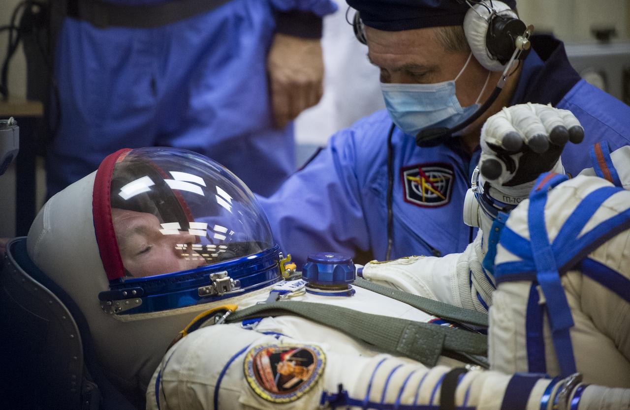 Expedition 41 Soyuz Commander Alexander Samokutyaev of the Russian Federal Space Agency (Roscosmos) has his Russian Sokol suit pressure checked in preparation for his launch onboard the Soyuz TMA-14M spacecraft on Thursday, September 25, 2014 at the Baikonur Cosmodrome in Kazakhstan.  The Soyuz spacecraft with Samokutyaev, Expedition 41 Flight Engineer Elena Serova of Roscosmos and Flight Engineer Barry Wilmore of NASA is scheduled to launch at 2:25 a.m. Kazakhstan Time on Friday, September 26. Photo Credit: (NASA/Joel Kowsky)