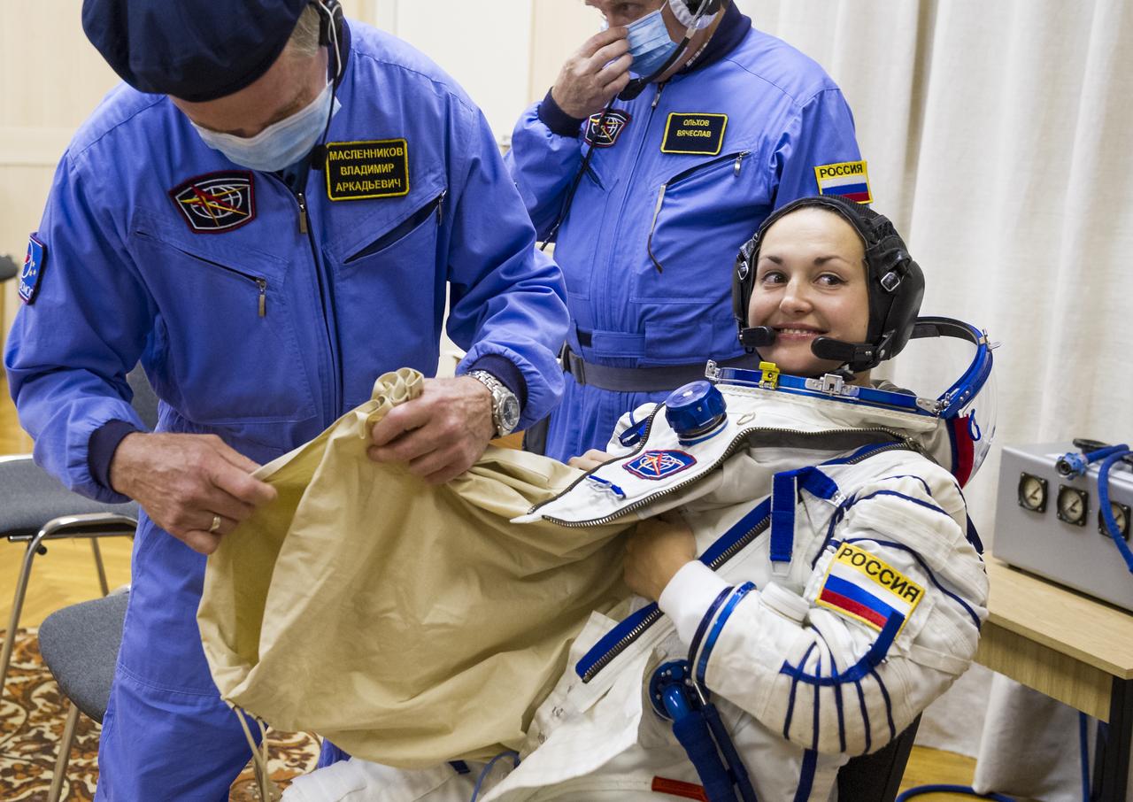 Expedition 41 Flight Engineer Elena Serova of the Russian Federal Space Agency (Roscosmos) is helped into her Russian Sokol suit as she and fellow crewmates, Soyuz Commander Alexander Samokutyaev of Roscosmos, and Flight Engineer Barry Wilmore of NASA prepare for their Soyuz launch to the International Space Station, on Thursday, Sept. 25, 2014, at the Baikonur Cosmodrome in Baikonur, Kazakhstan. Launch of the Soyuz rocket is scheduled for the early hours of Sept. 26 and will carry Serova, Wilmore, and Samokutyaev into orbit to begin their five and a half month mission on the International Space Station. Serova will become the fourth Russian woman to fly in space and the first Russian woman to live and work on the station. Photo Credit: (NASA/GCTC/Andrey Shelepin)