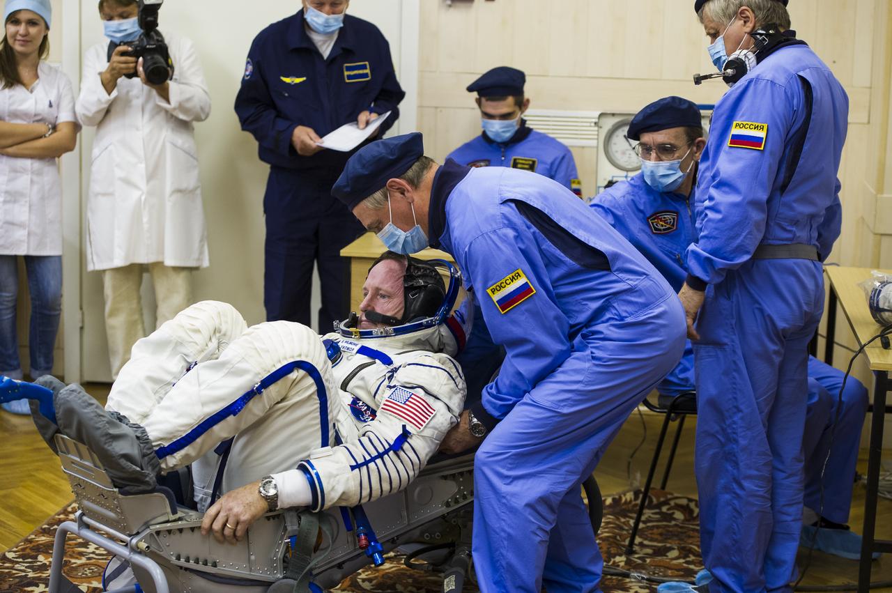Expedition 41 Flight Engineer Barry Wilmore of NASA has his Russian Sokol suit pressure checked in preparation for his launch aboard the Soyuz TMA-14M spacecraft on Thursday, Sept. 25, 2014, at the Baikonur Cosmodrome in Baikonur, Kazakhstan. Launch of the Soyuz rocket is scheduled for the early hours of Sept. 26 (Kazakhstan time) and will carry Wilmore and fellow crewmates, Flight Engineer Elena Serova and Soyuz Commander Alexander Samokutyaev of the Russian Federal Space Agency (Roscosmos), into orbit to begin their five and a half month mission on the International Space Station. Photo Credit: (NASA/GCTC/Andrey Shelepin)