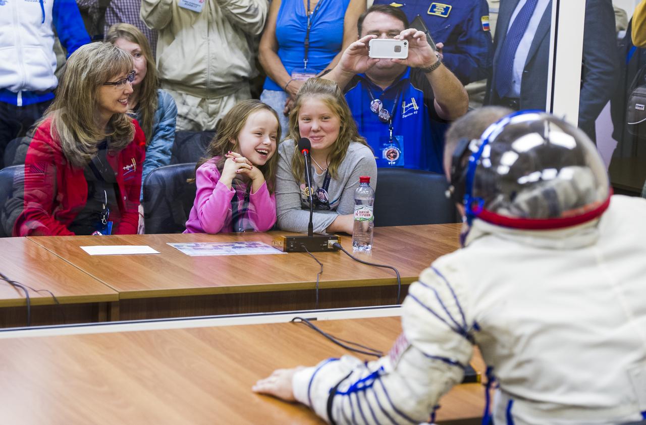 Expedition 41 Flight Engineer Barry Wilmore of NASA speaks with his family after having his Russian Sokol suit pressure checked in preparation for his launch onboard the Soyuz TMA-14M spacecraft on Thursday, Sept. 25, 2014 at the Baikonur Cosmodrome in Kazakhstan.  The Soyuz spacecraft with Wilmore, Soyuz Commander Alexander Samokutyaev of the Russian Federal Space Agency (Roscosmos), and Flight Engineer Elena Serova of Roscosmos is scheduled to launch at 2:25 a.m. Kazakhstan Time on Friday, Sept. 26. Photo Credit: (NASA/GCTC/Andrey Shelepin)
