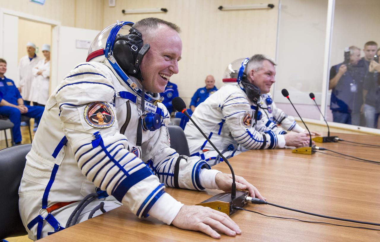Expedition 41 Soyuz Commander Alexander Samokutyaev of the Russian Federal Space Agency, Roscosmos, left, and Flight Engineer Barry Wilmore of NASA, right, are seen as they talk with family members after having their Russian Sokol suit pressure checked in preparation for their launch onboard the Soyuz TMA-14M spacecraft on Thursday, Sept. 25, 2014 at the Baikonur Cosmodrome in Kazakhstan.  The Soyuz spacecraft with Samokutyaev, Wilmore, and Flight Engineer Elena Serova of Roscosmos is scheduled to launch at 2:25 a.m. Kazakhstan time on Friday, Sept. 26. Photo Credit: (NASA/GCTC/Andrey Shelepin)