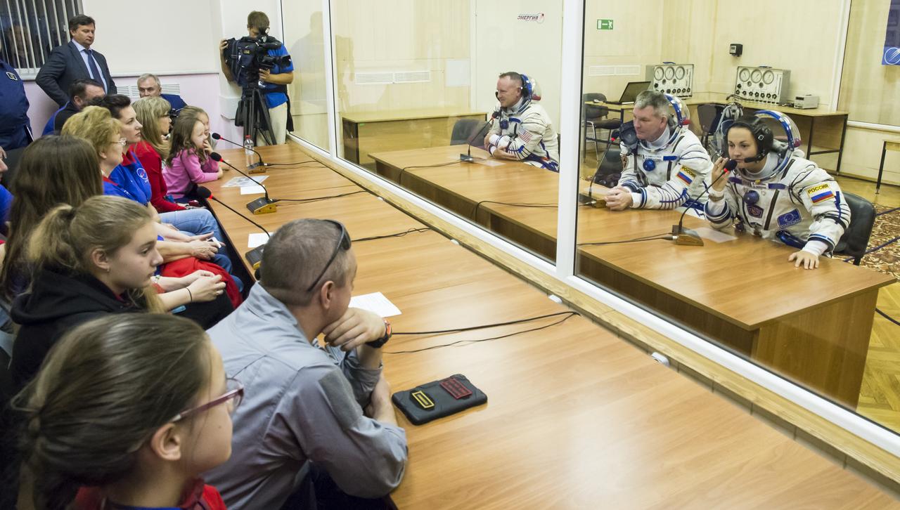 Expedition 41 Flight Engineer Barry Wilmore of NASA, left, Soyuz Commander Alexander Samokutyaev of the Russian Federal Space Agency, (Roscosmos), center, and Flight Engineer Elena Serova of Roscosmos, right, are seen as they talk with family members after having their Russian Sokol suits pressure checked in preparation for their launch onboard the Soyuz TMA-14M spacecraft on Thursday, Sept. 25, 2014 at the Baikonur Cosmodrome in Baikonur, Kazakhstan. The Soyuz spacecraft with Wilmore, Samokutyaev, and Serova is scheduled to launch at 2:25 a.m. Kazakhstan time on Friday, Sept. 26. Photo Credit: (NASA/Victor Zelentsov)