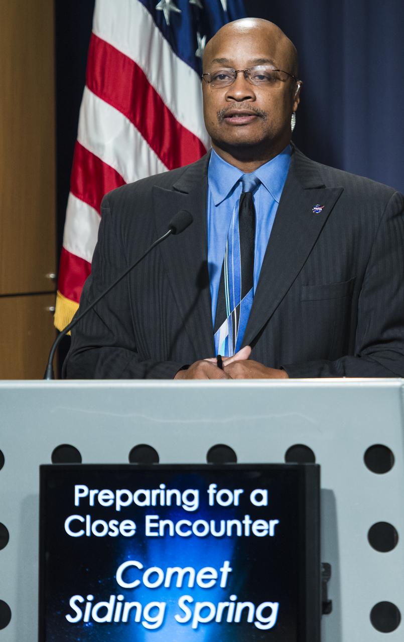 Dwayne Brown, NASA public affairs officer, moderates a media briefing where panelists outlined how space and Earth-based assets will be used to image and study comet Siding Spring during its Sunday, Oct. 19 flyby of Mars, Thursday, Oct. 9, 2014 at NASA Headquarters in Washington.  Photo Credit: (NASA/Joel Kowsky)