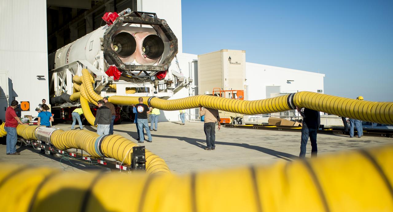 The Orbital Sciences Corporation Antares rocket, with the Cygnus spacecraft onboard, is rolled out of the Horizontal Integration Facility (HIF) to launch Pad-0A, Friday, Oct. 24, 2014, at NASA's Wallops Flight Facility in Virginia. The Antares will launch with the Cygnus spacecraft filled with over 5,000 pounds of supplies for the International Space Station, including science experiments, experiment hardware, spare parts, and crew provisions. The Orbital-3 mission is Orbital Sciences' third contracted cargo delivery flight to the space station for NASA. Photo Credit: (NASA/Joel Kowsky)