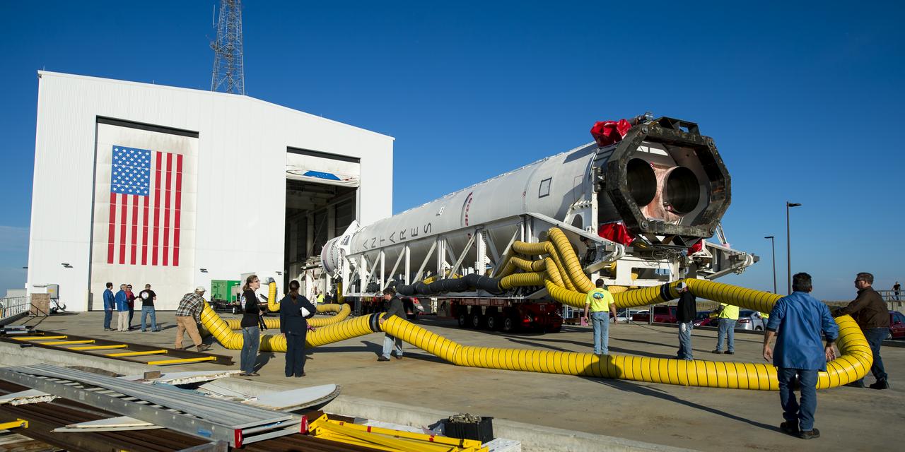 The Orbital Sciences Corporation Antares rocket, with the Cygnus spacecraft onboard, is rolled out of the Horizontal Integration Facility (HIF) to launch Pad-0A, Friday, Oct. 24, 2014, at NASA's Wallops Flight Facility in Virginia. The Antares will launch with the Cygnus spacecraft filled with over 5,000 pounds of supplies for the International Space Station, including science experiments, experiment hardware, spare parts, and crew provisions. The Orbital-3 mission is Orbital Sciences' third contracted cargo delivery flight to the space station for NASA. Photo Credit: (NASA/Joel Kowsky)