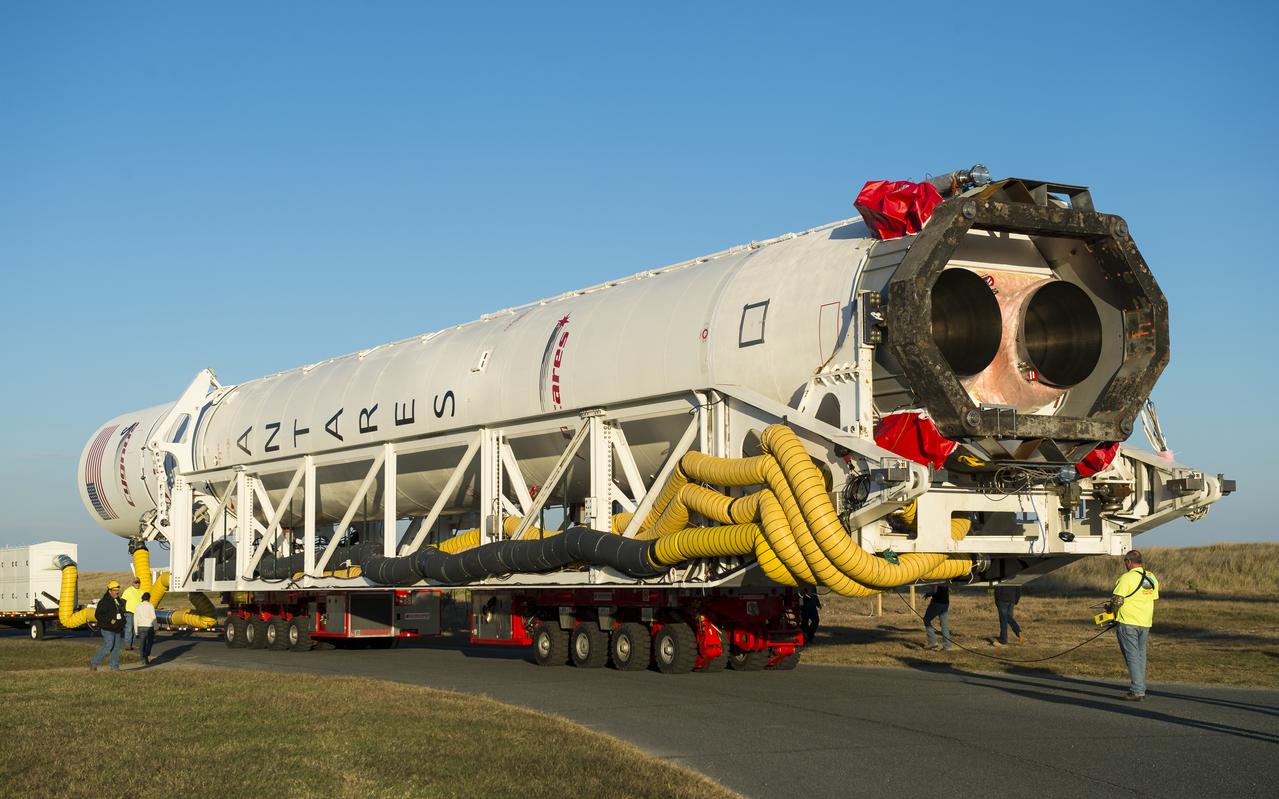 The Orbital Sciences Corporation Antares rocket, with the Cygnus spacecraft onboard, rolls from the Horizontal Integration Facility (HIF) to launch Pad-0A, Friday, Oct. 24, 2014, at NASA's Wallops Flight Facility in Virginia. The Antares will launch with the Cygnus spacecraft filled with over 5,000 pounds of supplies for the International Space Station, including science experiments, experiment hardware, spare parts, and crew provisions. The Orbital-3 mission is Orbital Sciences' third contracted cargo delivery flight to the space station for NASA. Photo Credit: (NASA/Joel Kowsky)
