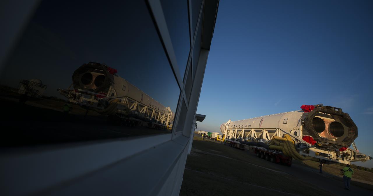 The Orbital Sciences Corporation Antares rocket, with the Cygnus spacecraft onboard, rolls from the Horizontal Integration Facility (HIF) to launch Pad-0A, Friday, Oct. 24, 2014, at NASA's Wallops Flight Facility in Virginia. The Antares will launch with the Cygnus spacecraft filled with over 5,000 pounds of supplies for the International Space Station, including science experiments, experiment hardware, spare parts, and crew provisions. The Orbital-3 mission is Orbital Sciences' third contracted cargo delivery flight to the space station for NASA. Photo Credit: (NASA/Joel Kowsky)