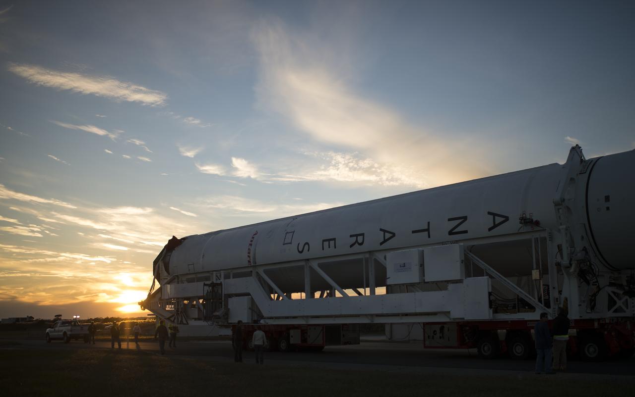 The Orbital Sciences Corporation Antares rocket, with the Cygnus spacecraft onboard, rolls from the Horizontal Integration Facility (HIF) to launch Pad-0A, Friday, Oct. 24, 2014, at NASA's Wallops Flight Facility in Virginia. The Antares will launch with the Cygnus spacecraft filled with over 5,000 pounds of supplies for the International Space Station, including science experiments, experiment hardware, spare parts, and crew provisions. The Orbital-3 mission is Orbital Sciences' third contracted cargo delivery flight to the space station for NASA. Photo Credit: (NASA/Joel Kowsky)