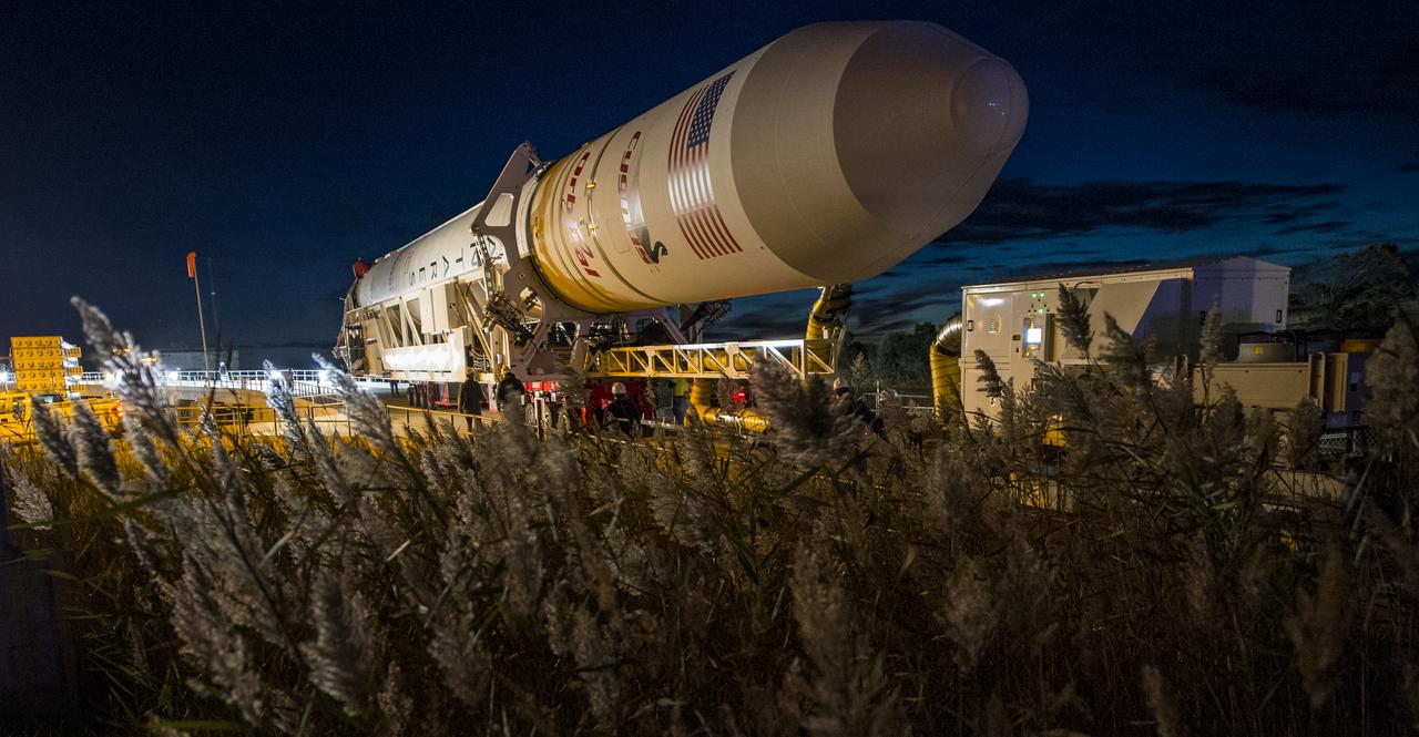 The Orbital Sciences Corporation Antares rocket, with the Cygnus spacecraft onboard, arrives at launch Pad-0A, Friday, Oct. 24, 2014, at NASA's Wallops Flight Facility in Virginia. The Antares will launch with the Cygnus spacecraft filled with over 5,000 pounds of supplies for the International Space Station, including science experiments, experiment hardware, spare parts, and crew provisions. The Orbital-3 mission is Orbital Sciences' third contracted cargo delivery flight to the space station for NASA. Photo Credit: (NASA/Joel Kowsky)