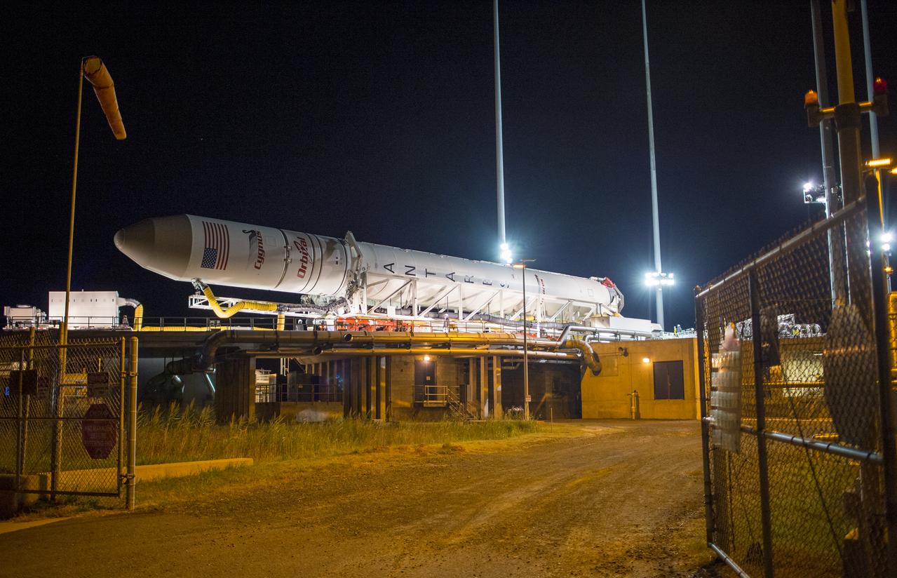 The Orbital Sciences Corporation Antares rocket, with the Cygnus spacecraft onboard, arrives at launch Pad-0A, Friday, Oct. 24, 2014, at NASA's Wallops Flight Facility in Virginia. The Antares will launch with the Cygnus spacecraft filled with over 5,000 pounds of supplies for the International Space Station, including science experiments, experiment hardware, spare parts, and crew provisions. The Orbital-3 mission is Orbital Sciences' third contracted cargo delivery flight to the space station for NASA. Photo Credit: (NASA/Joel Kowsky)