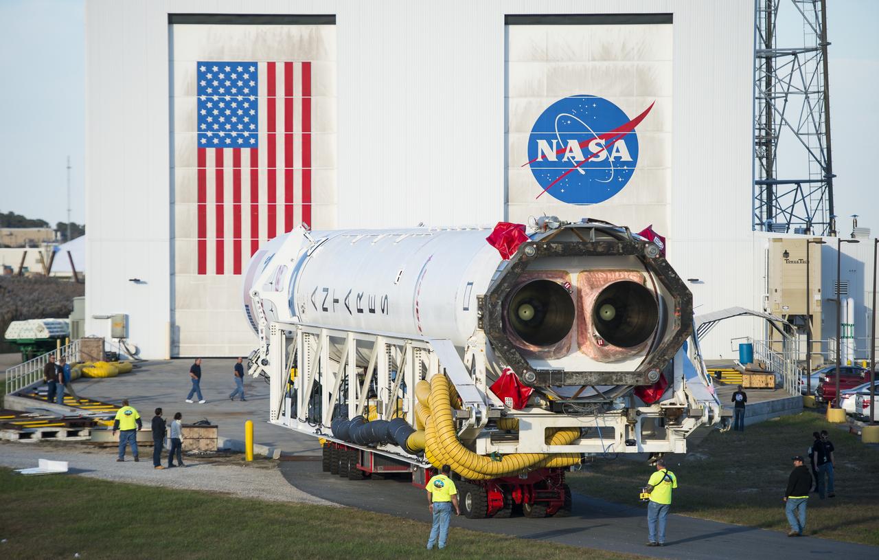 The Orbital Sciences Corporation Antares rocket, with the Cygnus spacecraft onboard, rolls from the Horizontal Integration Facility (HIF) to launch Pad-0A, Friday, Oct. 24, 2014, at NASA's Wallops Flight Facility in Virginia. The Antares will launch with the Cygnus spacecraft filled with over 5,000 pounds of supplies for the International Space Station, including science experiments, experiment hardware, spare parts, and crew provisions. The Orbital-3 mission is Orbital Sciences' third contracted cargo delivery flight to the space station for NASA. Photo Credit: (NASA/Joel Kowsky)