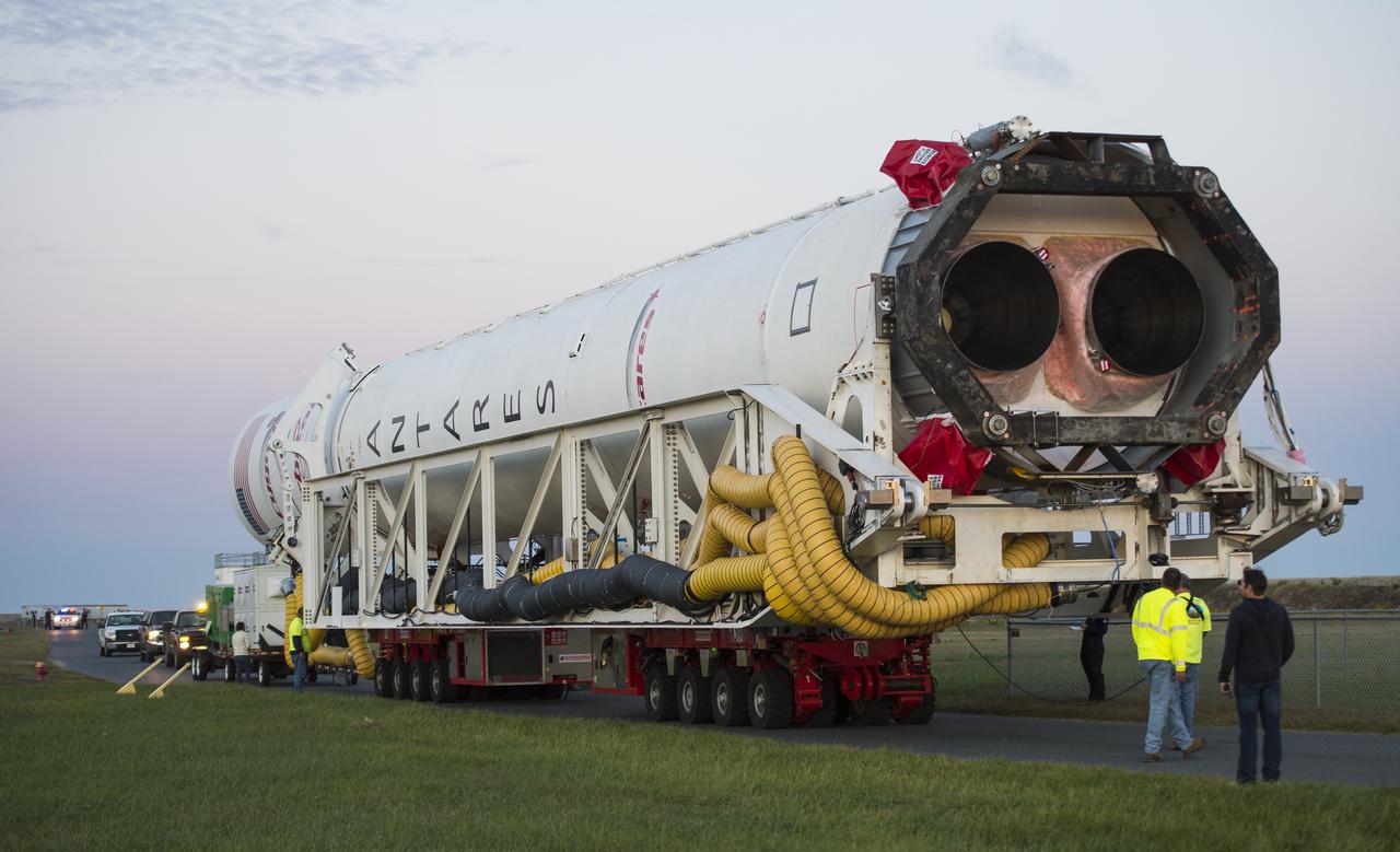 The Orbital Sciences Corporation Antares rocket, with the Cygnus spacecraft onboard, rolls from the Horizontal Integration Facility (HIF) to launch Pad-0A, Friday, Oct. 24, 2014, at NASA's Wallops Flight Facility in Virginia. The Antares will launch with the Cygnus spacecraft filled with over 5,000 pounds of supplies for the International Space Station, including science experiments, experiment hardware, spare parts, and crew provisions. The Orbital-3 mission is Orbital Sciences' third contracted cargo delivery flight to the space station for NASA. Photo Credit: (NASA/Joel Kowsky)