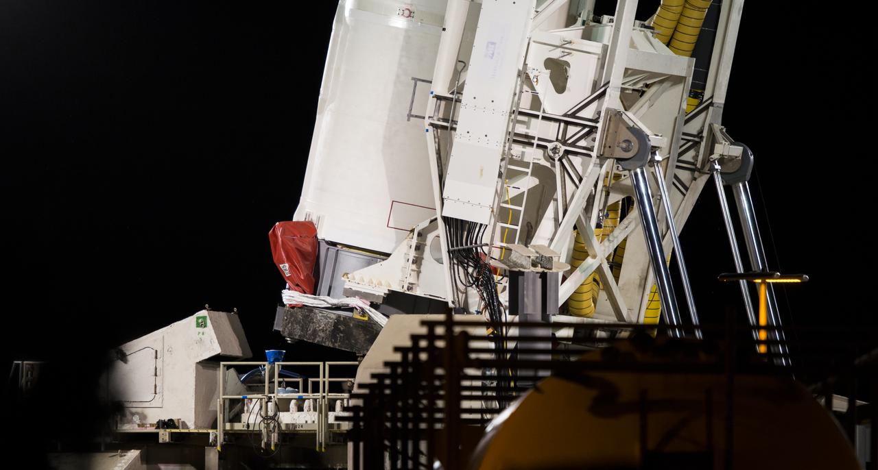 The Orbital Sciences Corporation Antares rocket, with the Cygnus spacecraft onboard, is raised at launch Pad-0A, Saturday, Oct. 25, 2014, at NASA's Wallops Flight Facility in Virginia. The Antares will launch with the Cygnus spacecraft filled with over 5,000 pounds of supplies for the International Space Station, including science experiments, experiment hardware, spare parts, and crew provisions. The Orbital-3 mission is Orbital Sciences' third contracted cargo delivery flight to the space station for NASA. Photo Credit: (NASA/Joel Kowsky)