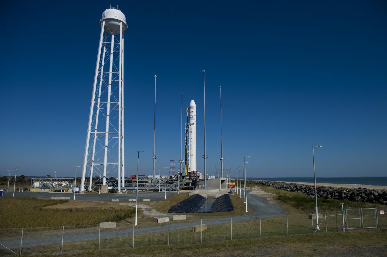 The Orbital Sciences Corporation Antares rocket, with the Cygnus spacecraft onboard, is seen on launch Pad-0A, Saturday, Oct. 25, 2014, at NASA's Wallops Flight Facility in Virginia. The Antares will launch with the Cygnus spacecraft filled with over 5,000 pounds of supplies for the International Space Station, including science experiments, experiment hardware, spare parts, and crew provisions. The Orbital-3 mission is Orbital Sciences' third contracted cargo delivery flight to the space station for NASA.  Launch is scheduled for Monday, Oct. 27 at 6:45 p.m. EDT.  Photo Credit: (NASA/Joel Kowsky)