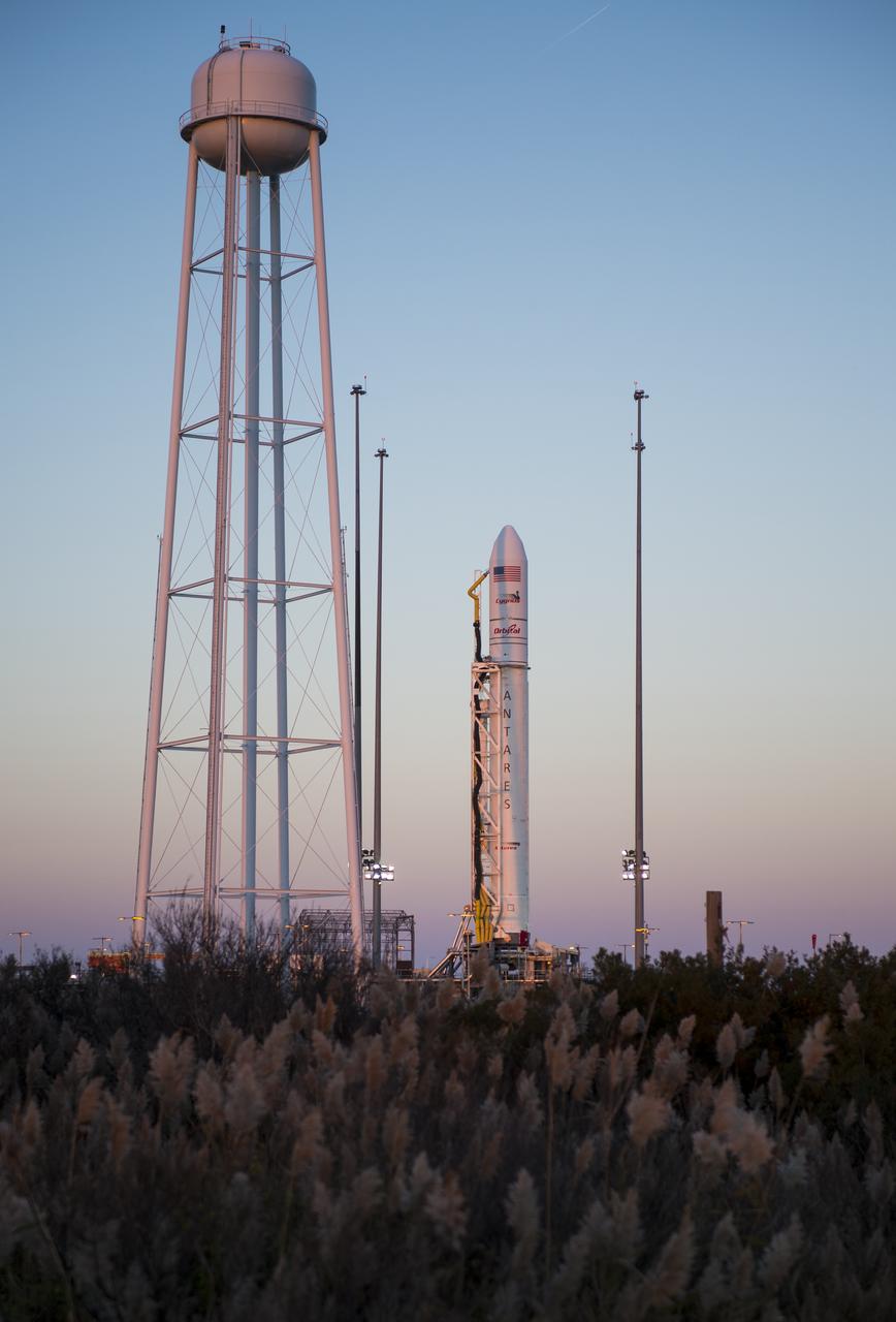 The Orbital Sciences Corporation Antares rocket, with the Cygnus spacecraft onboard, is seen on launch Pad-0A, Saturday, Oct. 25, 2014, at NASA's Wallops Flight Facility in Virginia. The Antares will launch with the Cygnus spacecraft filled with over 5,000 pounds of supplies for the International Space Station, including science experiments, experiment hardware, spare parts, and crew provisions. The Orbital-3 mission is Orbital Sciences' third contracted cargo delivery flight to the space station for NASA.  Launch is scheduled for Monday, Oct. 27 at 6:45 p.m. EDT.  Photo Credit: (NASA/Joel Kowsky)