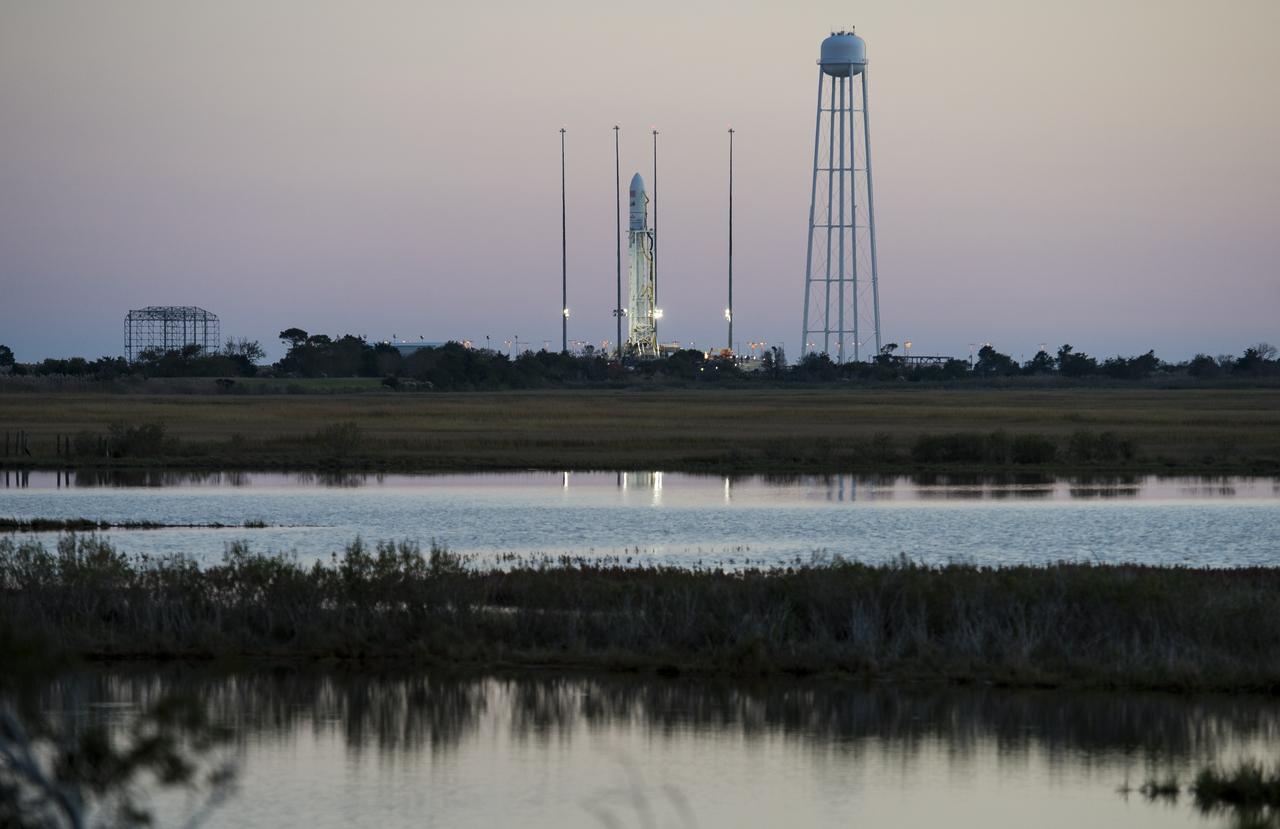 The Orbital Sciences Corporation Antares rocket, with the Cygnus spacecraft onboard, is seen on launch Pad-0A, Saturday, Oct. 25, 2014, at NASA's Wallops Flight Facility in Virginia. The Antares will launch with the Cygnus spacecraft filled with over 5,000 pounds of supplies for the International Space Station, including science experiments, experiment hardware, spare parts, and crew provisions. The Orbital-3 mission is Orbital Sciences' third contracted cargo delivery flight to the space station for NASA.  Launch is scheduled for Monday, Oct. 27 at 6:45 p.m. EDT.  Photo Credit: (NASA/Joel Kowsky)