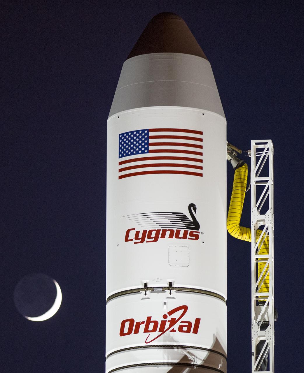 The Orbital Sciences Corporation Antares rocket, with the Cygnus spacecraft onboard, is seen on launch Pad-0A, Sunday, Oct. 26, 2014, at NASA's Wallops Flight Facility in Virginia. The Antares will launch with the Cygnus spacecraft filled with over 5,000 pounds of supplies for the International Space Station, including science experiments, experiment hardware, spare parts, and crew provisions. The Orbital-3 mission is Orbital Sciences' third contracted cargo delivery flight to the space station for NASA. Launch is scheduled for Monday, Oct. 27 at 6:45 p.m. EDT. Photo Credit: (NASA/Joel Kowsky)