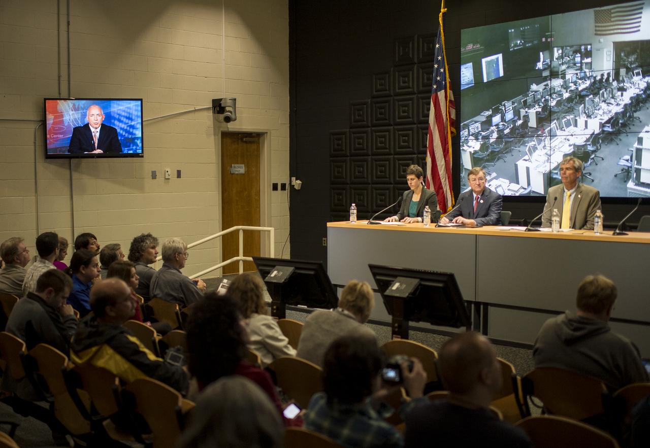 Michael Suffredini, NASA's International Space Station Program Manager participates via phone, in a press conference with Rachel Kraft, NASA public affairs officer, seated left, Frank Culbertson, Executive Vice President and General Manager of Advanced Program Group at Orbital Sciences Corp., center, and Bill Wrobel, director of NASA's Wallops Flight Facility, after a mishap occurred during the launch of the Antares rocket, with the Cygnus cargo spacecraft aboard, Tuesday, Oct. 28, 2014, NASA Wallops Flight Facility, Virginia. William Gerstenmaier, associate administrator of NASA's Human Exploration and Operations Mission Directorate also participated via phone. Cygnus was on its way to rendezvous with the space station. The Antares rocket lifted off to start its third resupply mission to the International Space Station, but suffered a catastrophic anomaly shortly after liftoff at 6:22 p.m. EDT. Photo Credit: (NASA/Joel Kowsky)