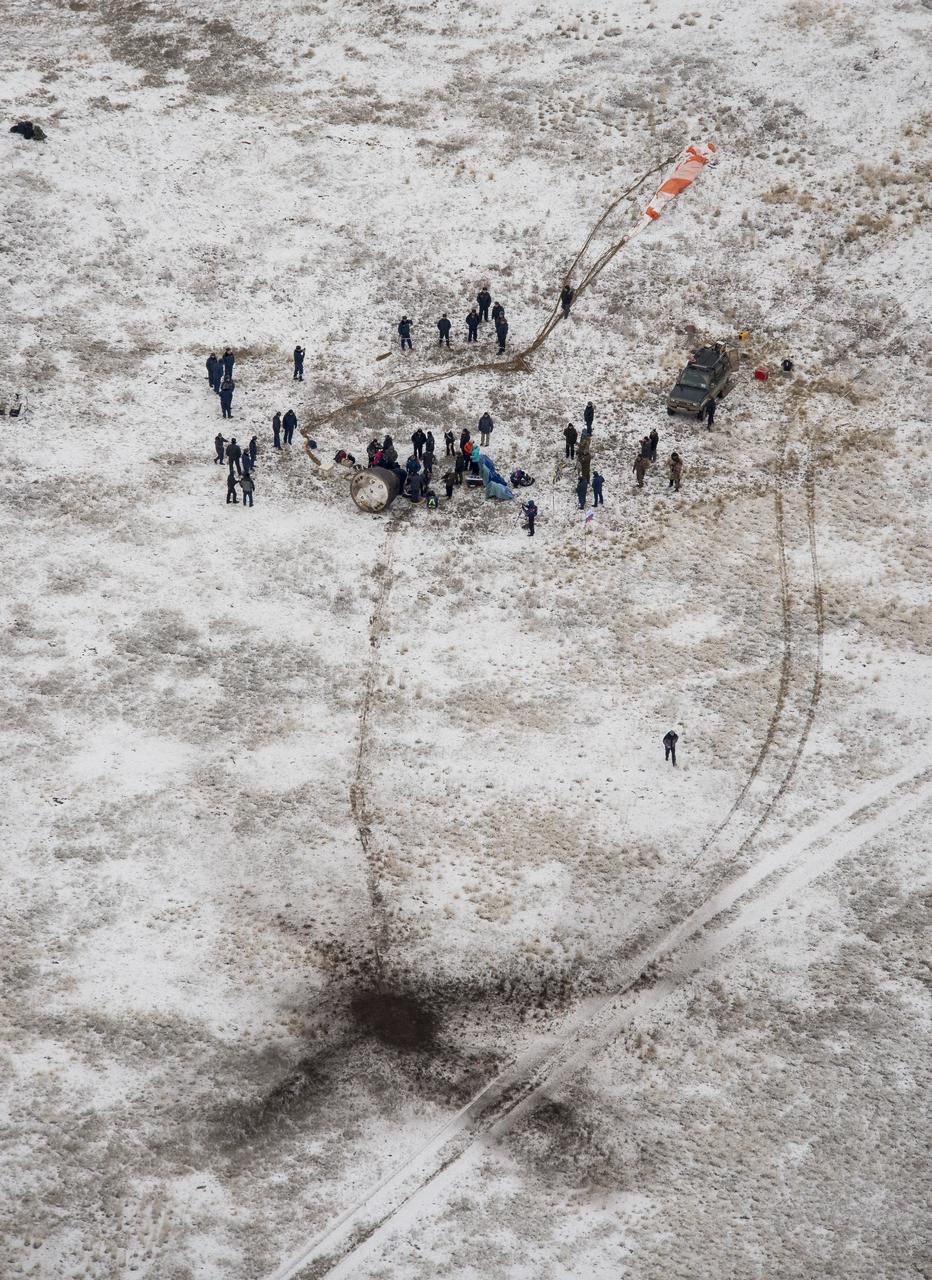 Ground support personnel are seen at the landing site after the Soyuz TMA-13M spacecraft landed with Expedition 41 Commander Max Suraev of the Russian Federal Space Agency (Roscosmos), NASA Flight Engineer Reid Wiseman and Flight Engineer Alexander Gerst of the European Space Agency (ESA) near the town of Arkalyk, Kazakhstan on Monday, Nov. 10, 2014. Suraev, Wiseman and Gerst returned to Earth after more than five months onboard the International Space Station where they served as members of the Expedition 40 and 41 crews. Photo Credit: (NASA/Bill Ingalls)