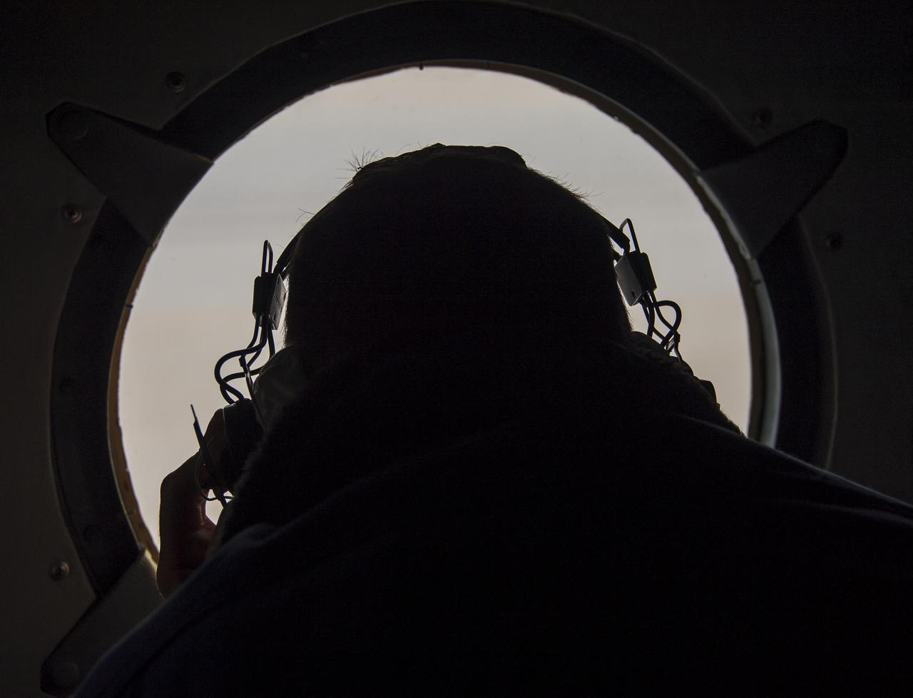 A Russian search and rescue team member looks out a helicopter window as they fly from Kustanay, Kazakhstan to support the Soyuz TMA-13M spacecraft landing with Expedition 41 Commander Max Suraev of the Russian Federal Space Agency (Roscosmos), NASA Flight Engineer Reid Wiseman and Flight Engineer Alexander Gerst of the European Space Agency (ESA) on Monday, Nov. 10, 2014. Suraev, Wiseman and Gerst returned to Earth after more than five months onboard the International Space Station where they served as members of the Expedition 40 and 41 crews. Photo Credit: (NASA/Bill Ingalls)