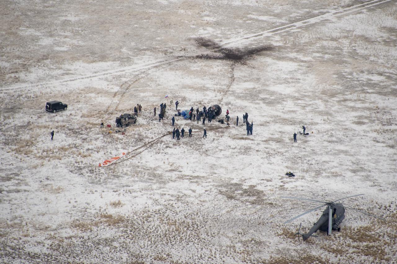 Ground support personnel are seen at the landing site after the Soyuz TMA-13M spacecraft landed with Expedition 41 Commander Max Suraev of the Russian Federal Space Agency (Roscosmos), NASA Flight Engineer Reid Wiseman and Flight Engineer Alexander Gerst of the European Space Agency (ESA) near the town of Arkalyk, Kazakhstan on Monday, Nov. 10, 2014. Suraev, Wiseman and Gerst returned to Earth after more than five months onboard the International Space Station where they served as members of the Expedition 40 and 41 crews. Photo Credit: (NASA/Bill Ingalls)