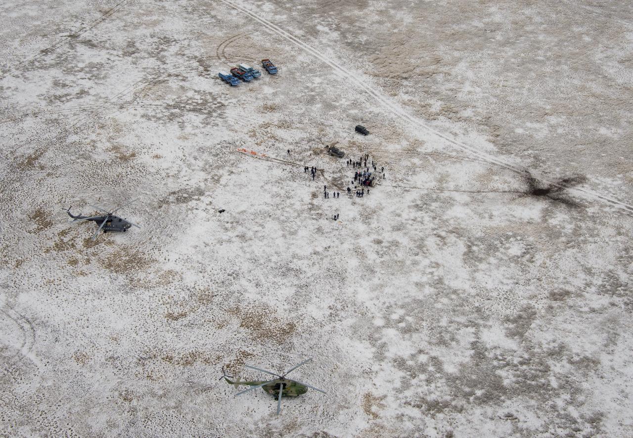Ground support personnel are seen at the landing site after the Soyuz TMA-13M spacecraft landed with Expedition 41 Commander Max Suraev of the Russian Federal Space Agency (Roscosmos), NASA Flight Engineer Reid Wiseman and Flight Engineer Alexander Gerst of the European Space Agency (ESA) near the town of Arkalyk, Kazakhstan on Monday, Nov. 10, 2014. Suraev, Wiseman and Gerst returned to Earth after more than five months onboard the International Space Station where they served as members of the Expedition 40 and 41 crews. Photo Credit: (NASA/Bill Ingalls)
