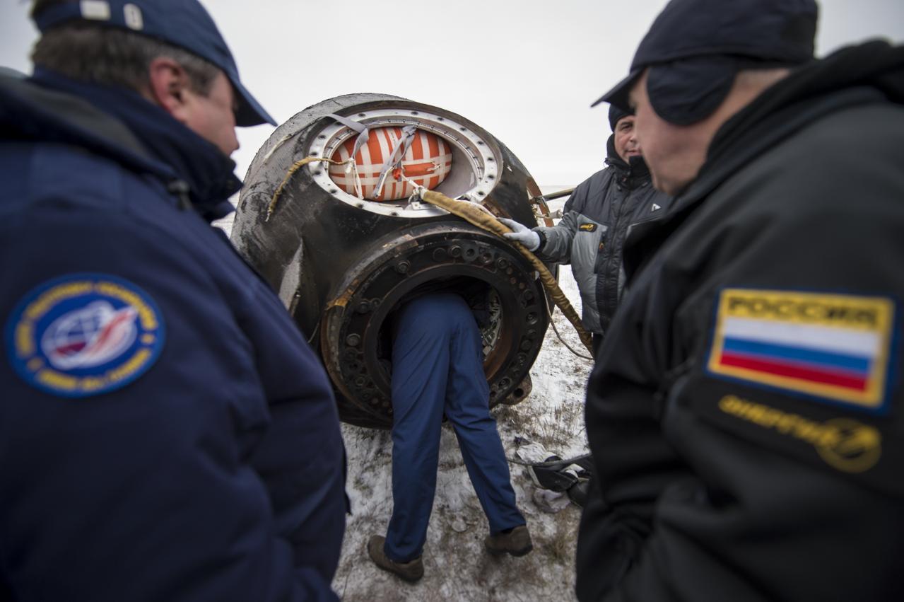 Ground support personnel work to extract Expedition 41 Commander Max Suraev of the Russian Federal Space Agency (Roscosmos), NASA Flight Engineer Reid Wiseman and Flight Engineer Alexander Gerst of the European Space Agency (ESA) from the Soyuz TMA-13M spacecraft after it landed near the town of Arkalyk, Kazakhstan on Monday, Nov. 10, 2014. Suraev, Wiseman and Gerst returned to Earth after more than five months onboard the International Space Station where they served as members of the Expedition 40 and 41 crews. Photo Credit: (NASA/Bill Ingalls)