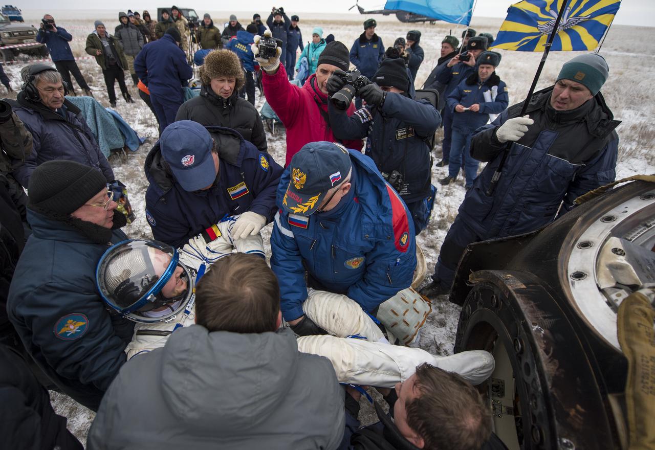 Expedition 41 Flight Engineer Alexander Gerst of the European Space Agency (ESA) is helped out of the Soyuz Capsule just minutes after he and Expedition 41 Commander Max Suraev of the Russian Federal Space Agency (Roscosmos), and NASA Flight Engineer Reid Wiseman landed in their Soyuz TMA-13M capsule in a remote area near the town of Arkalyk, Kazakhstan on Monday, Nov. 10, 2014. Suraev, Wiseman and Gerst returned to Earth after more than five months onboard the International Space Station where they served as members of the Expedition 40 and 41 crews. Photo Credit: (NASA/Bill Ingalls)