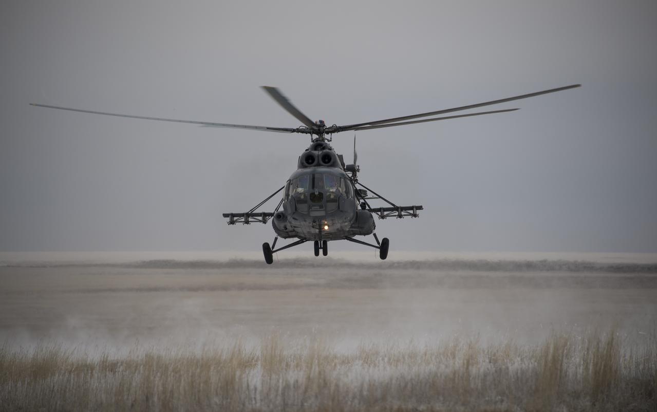 A Russian search and rescue helicopter arrives at the Soyuz TMA-13M spacecraft landing site after the capsule landed with Expedition 41 Commander Max Suraev of the Russian Federal Space Agency (Roscosmos), NASA Flight Engineer Reid Wiseman and Flight Engineer Alexander Gerst of the European Space Agency (ESA) near the town of Arkalyk, Kazakhstan on Monday, Nov. 10, 2014. Suraev, Wiseman and Gerst returned to Earth after more than five months onboard the International Space Station where they served as members of the Expedition 40 and 41 crews. Photo Credit: (NASA/Bill Ingalls)