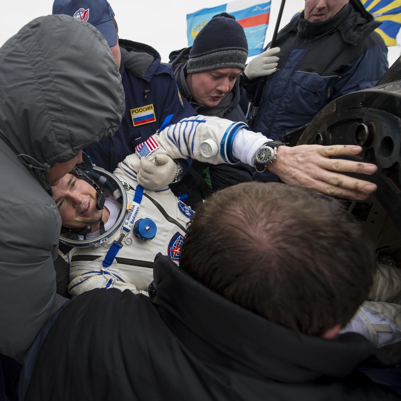 Expedition 41 Flight Engineer Reid Wiseman of NASA is helped out of the Soyuz Capsule just minutes after he and Expedition 41 Commander Max Suraev of the Russian Federal Space Agency (Roscosmos) and Flight Engineer Alexander Gerst of the European Space Agency (ESA) landed in their Soyuz TMA-13M capsule in a remote area near the town of Arkalyk, Kazakhstan on Monday, Nov. 10, 2014. Suraev, Wiseman and Gerst returned to Earth after more than five months onboard the International Space Station where they served as members of the Expedition 40 and 41 crews. Photo Credit: (NASA/Bill Ingalls)