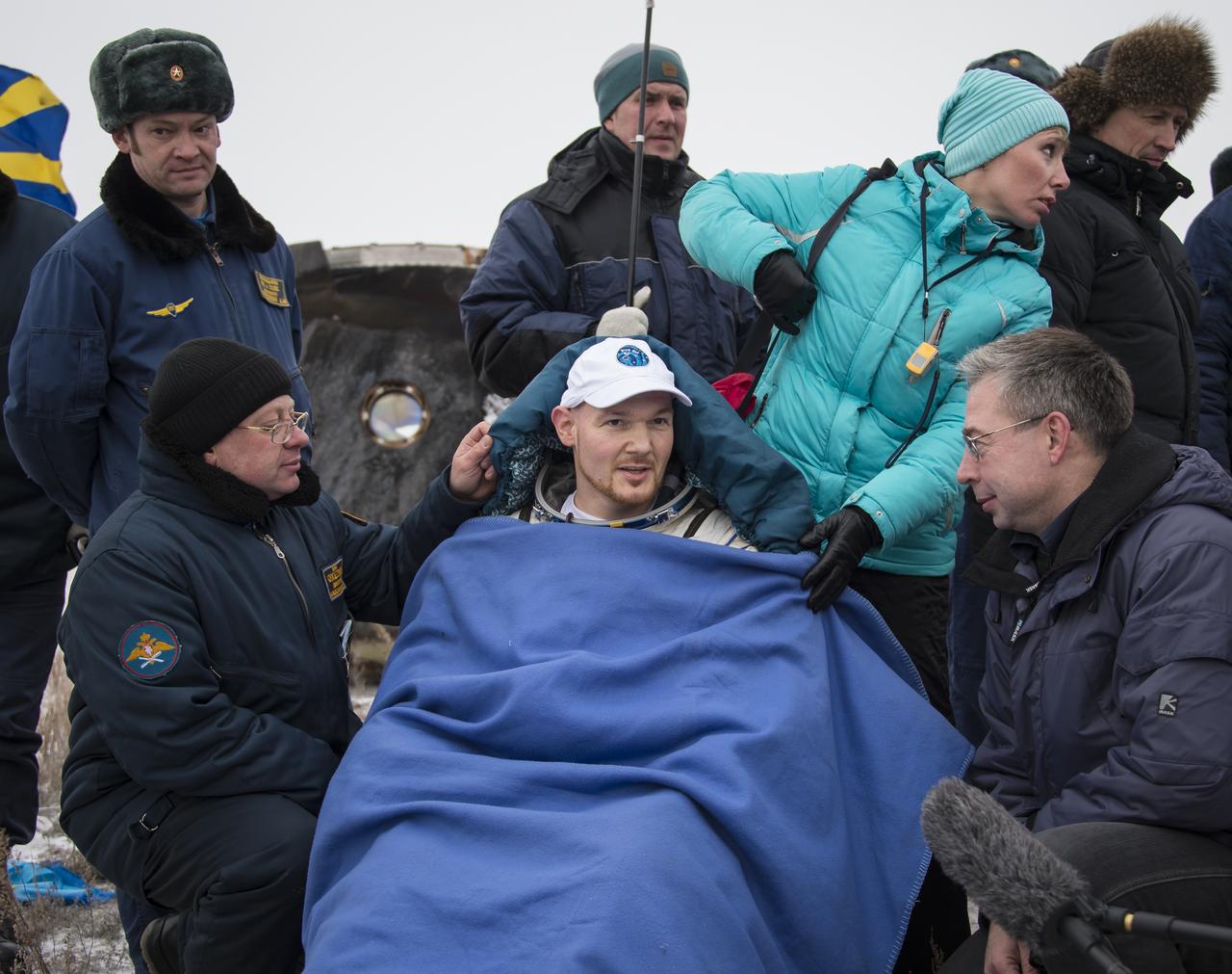 Expedition 41 Flight Engineer Alexander Gerst of the European Space Agency (ESA) rests in a chair outside the Soyuz Capsule just minutes after he and Expedition 41 Commander Max Suraev of the Russian Federal Space Agency (Roscosmos), and NASA Flight Engineer Reid Wiseman landed in their Soyuz TMA-13M capsule in a remote area near the town of Arkalyk, Kazakhstan on Monday, Nov. 10, 2014. Suraev, Wiseman and Gerst returned to Earth after more than five months onboard the International Space Station where they served as members of the Expedition 40 and 41 crews. Photo Credit: (NASA/Bill Ingalls)
