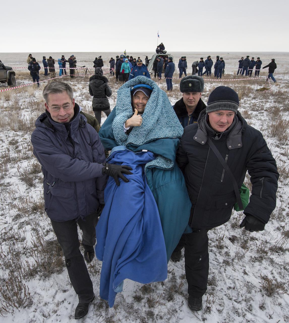 Expedition 41 Flight Engineer Reid Wiseman of NASA is carried in a chair to a medical tent after he and Expedition 41 Commander Max Suraev of the Russian Federal Space Agency (Roscosmos) and Flight Engineer Alexander Gerst of the European Space Agency (ESA) landed in their Soyuz TMA-13M capsule in a remote area near the town of Arkalyk, Kazakhstan on Monday, Nov. 10, 2014. Suraev, Wiseman and Gerst returned to Earth after more than five months onboard the International Space Station where they served as members of the Expedition 40 and 41 crews. Photo Credit: (NASA/Bill Ingalls)
