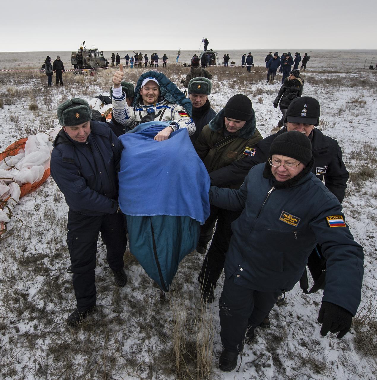 Expedition 41 Flight Engineer Alexander Gerst of the European Space Agency (ESA) is carried in a chair to a medical tent after he and Expedition 41 Commander Max Suraev of the Russian Federal Space Agency (Roscosmos), and NASA Flight Engineer Reid Wiseman landed in their Soyuz TMA-13M capsule in a remote area near the town of Arkalyk, Kazakhstan on Monday, Nov. 10, 2014. Suraev, Wiseman and Gerst returned to Earth after more than five months onboard the International Space Station where they served as members of the Expedition 40 and 41 crews. Photo Credit: (NASA/Bill Ingalls)