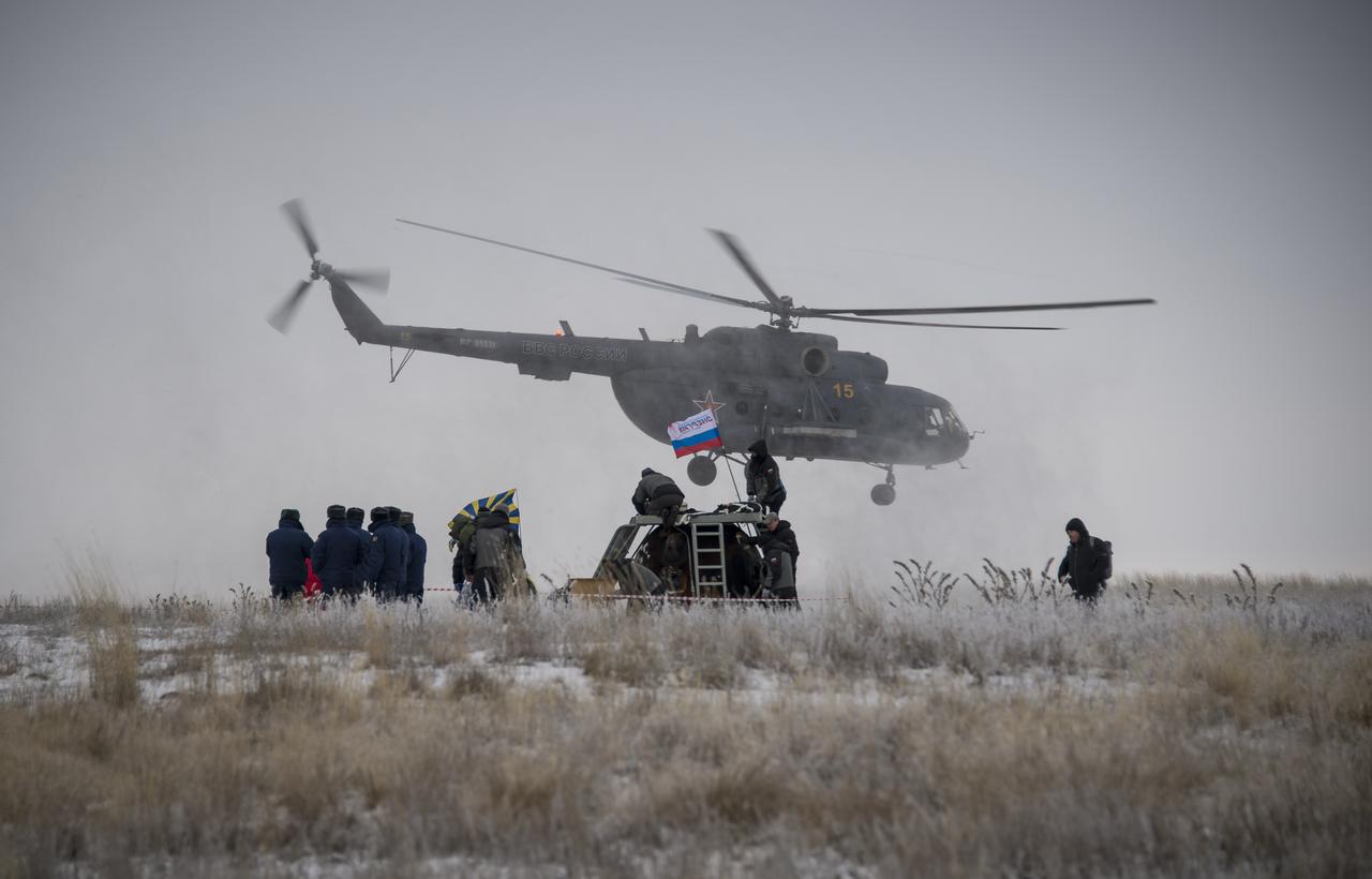 Ground support personnel are seen at the landing site after the Soyuz TMA-13M spacecraft landed with Expedition 41 Commander Max Suraev of the Russian Federal Space Agency (Roscosmos), NASA Flight Engineer Reid Wiseman and Flight Engineer Alexander Gerst of the European Space Agency (ESA) near the town of Arkalyk, Kazakhstan on Monday, Nov. 10, 2014. Suraev, Wiseman and Gerst returned to Earth after more than five months onboard the International Space Station where they served as members of the Expedition 40 and 41 crews. Photo Credit: (NASA/Bill Ingalls)