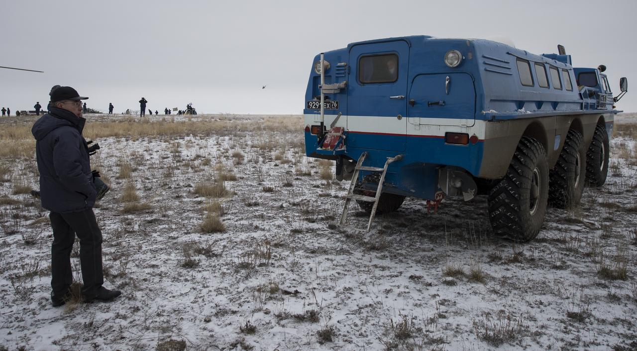 A Russian search and rescue all terrain vehicle (ATV) drives Expedition 41 Flight Engineer Reid Wiseman of NASA from the medical tent to his awaiting helicopter after he and Expedition 41 Commander Max Suraev of the Russian Federal Space Agency (Roscosmos) and Flight Engineer Alexander Gerst of the European Space Agency (ESA) landed in their Soyuz TMA-13M capsule in a remote area near the town of Arkalyk, Kazakhstan on Monday, Nov. 10, 2014. Suraev, Wiseman and Gerst returned to Earth after more than five months onboard the International Space Station where they served as members of the Expedition 40 and 41 crews. Photo Credit: (NASA/Bill Ingalls)