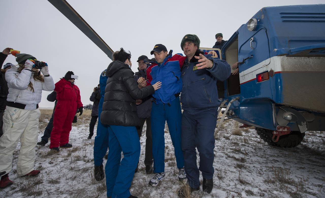Expedition 41 Flight Engineer Reid Wiseman of NASA is helped from a Russian search and rescue all terrain vehicle (ATV) to his awaiting helicopter after he and Expedition 41 Commander Max Suraev of the Russian Federal Space Agency (Roscosmos) and Flight Engineer Alexander Gerst of the European Space Agency (ESA) landed in their Soyuz TMA-13M capsule in a remote area near the town of Arkalyk, Kazakhstan on Monday, Nov. 10, 2014. Suraev, Wiseman and Gerst returned to Earth after more than five months onboard the International Space Station where they served as members of the Expedition 40 and 41 crews. Photo Credit: (NASA/Bill Ingalls)